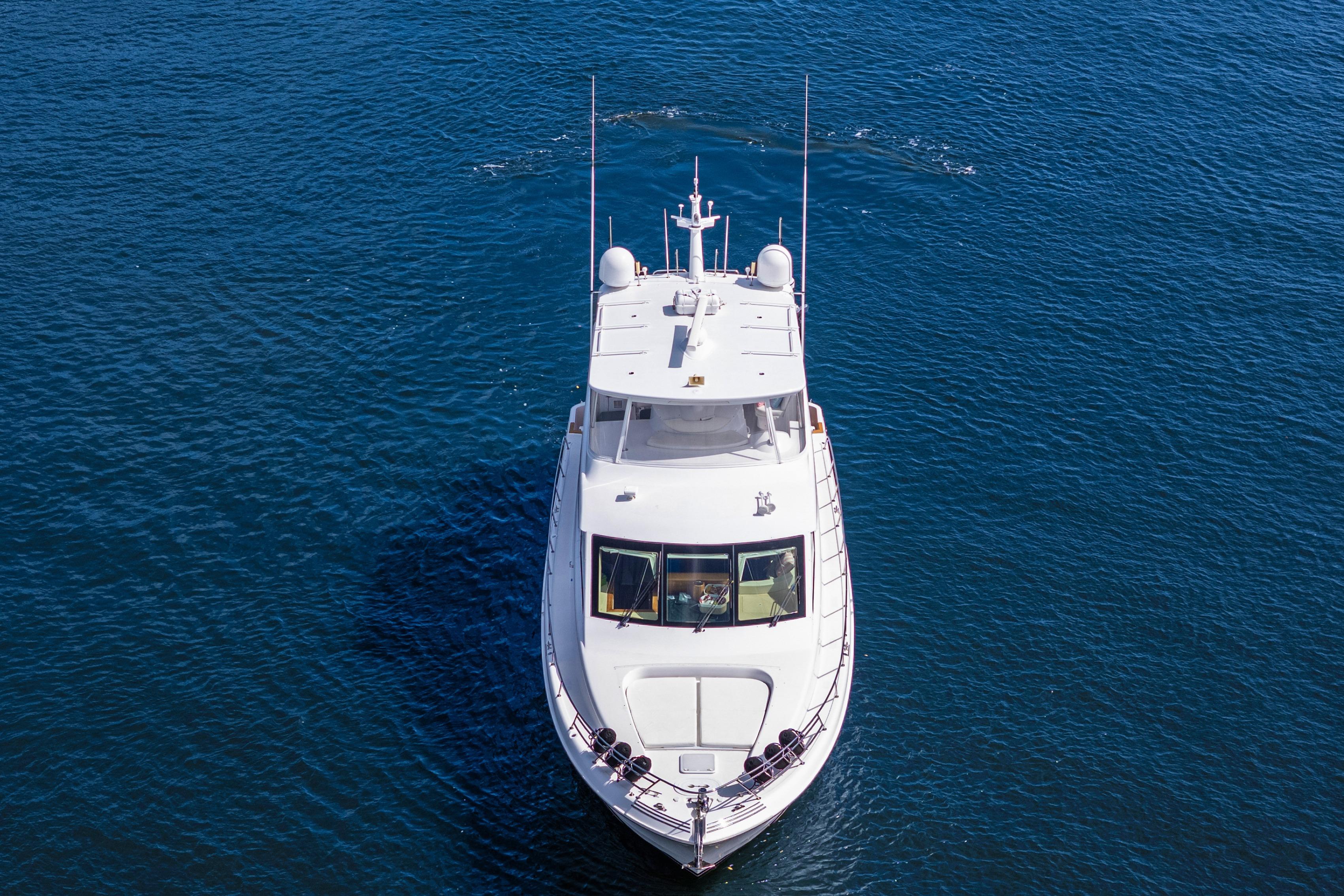 2008 Hatteras 64 Motor Yacht cruising on open blue water.