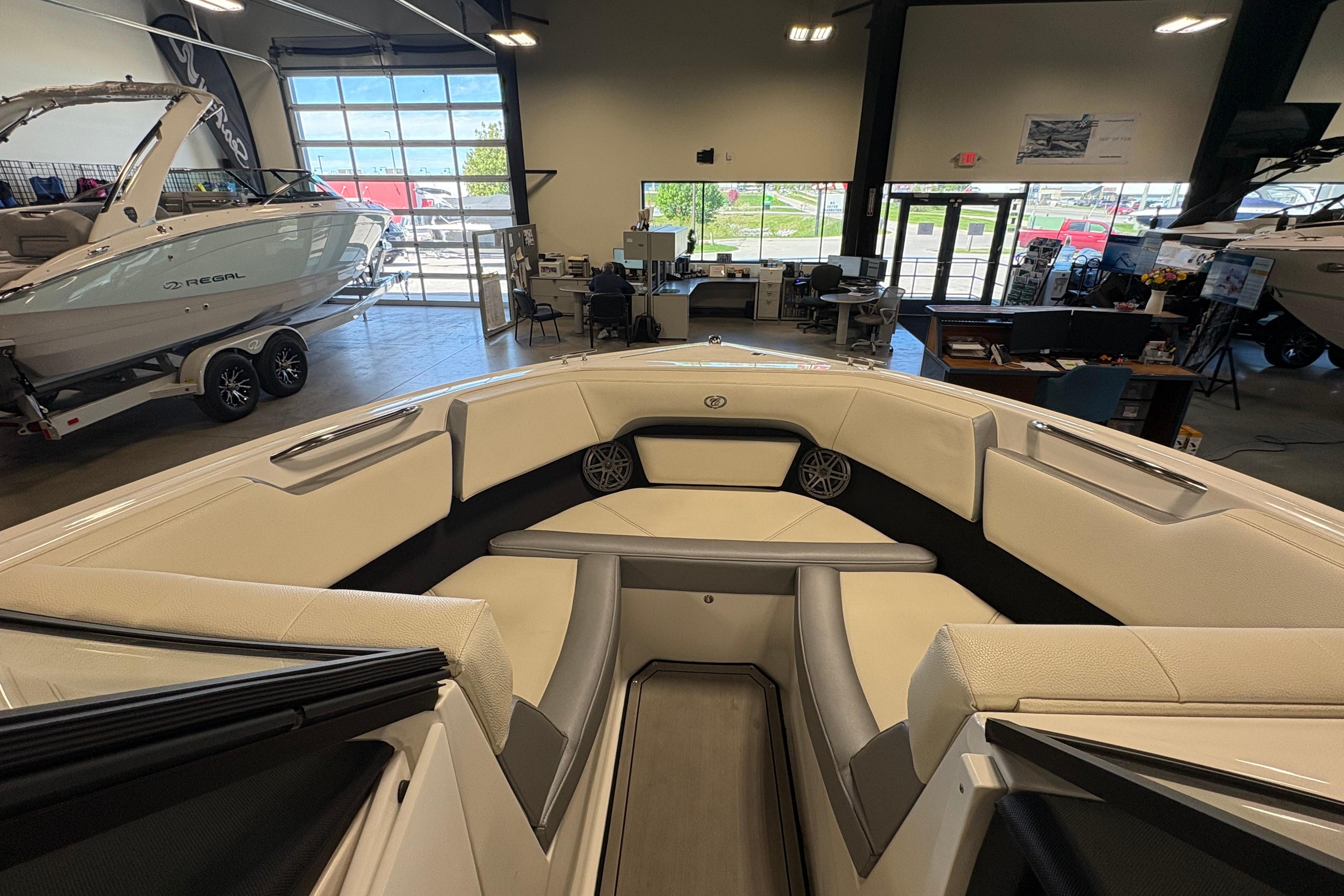 2021 Cobalt CS23 boat interior in showroom with luxury seating and modern design.