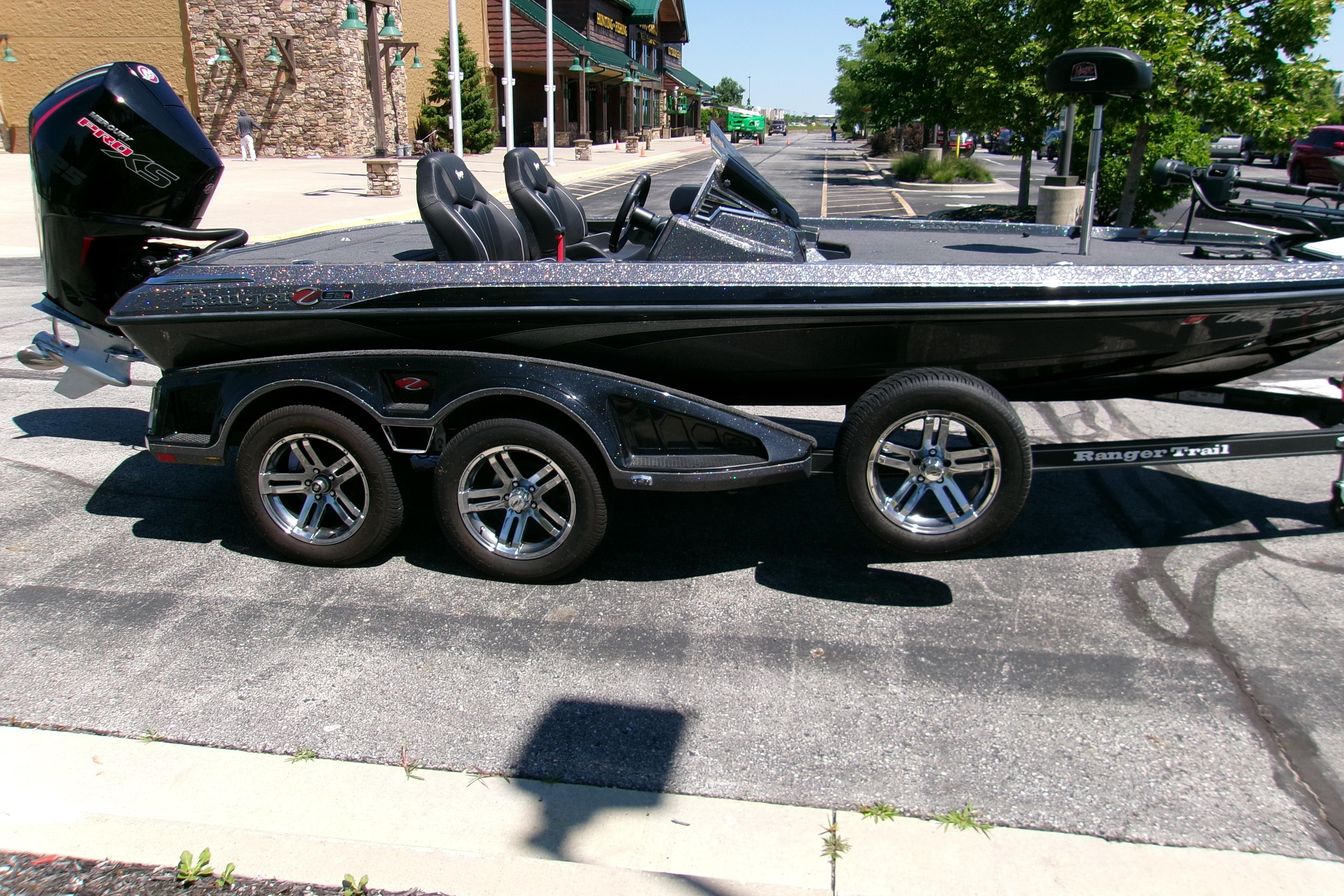 2025 Ranger Z519R Cup-Equipped boat on trailer, parked outdoors in sunny setting.