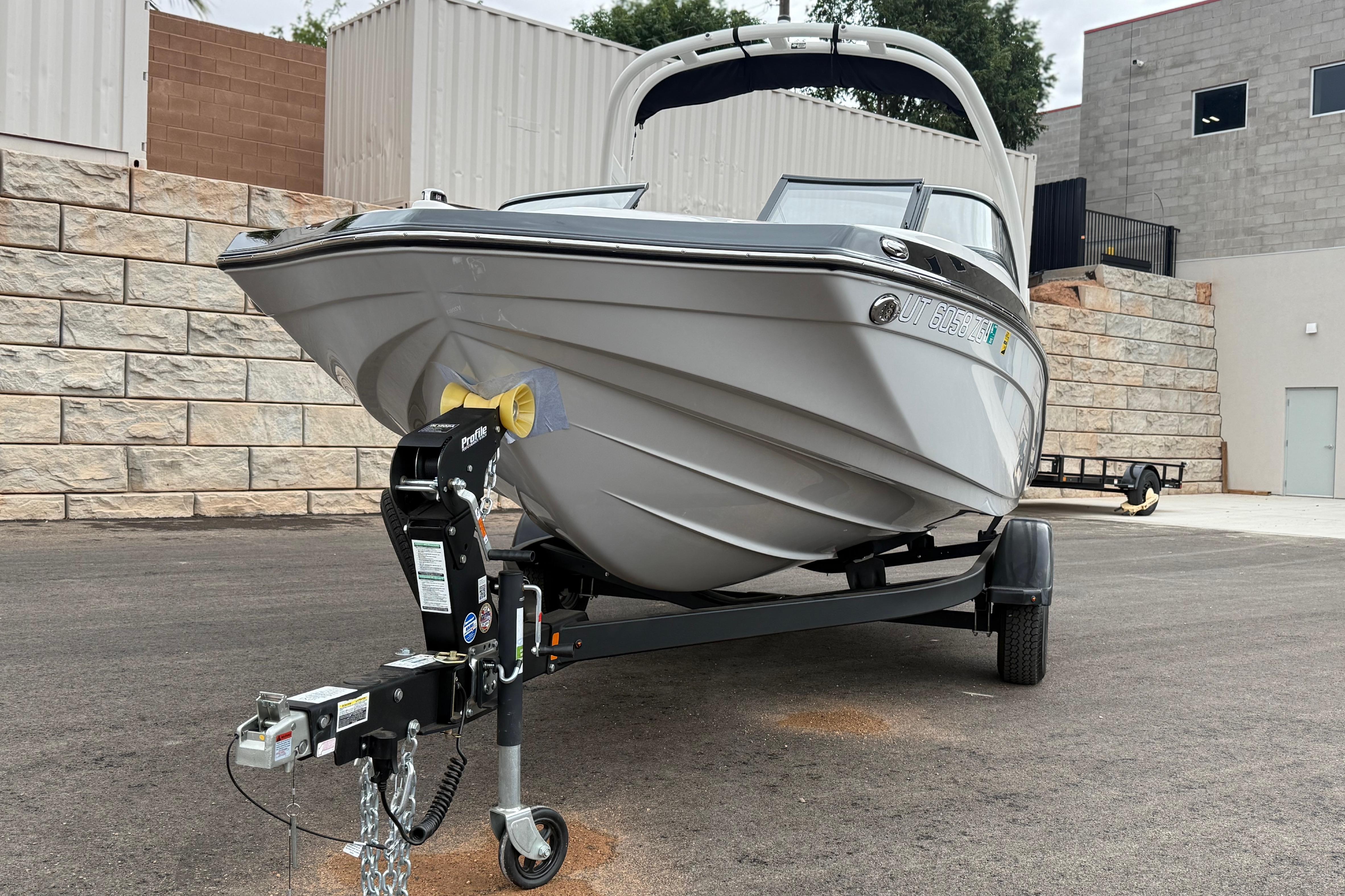 2025 Yamaha Boats 195S on trailer, parked outdoors near stone wall.