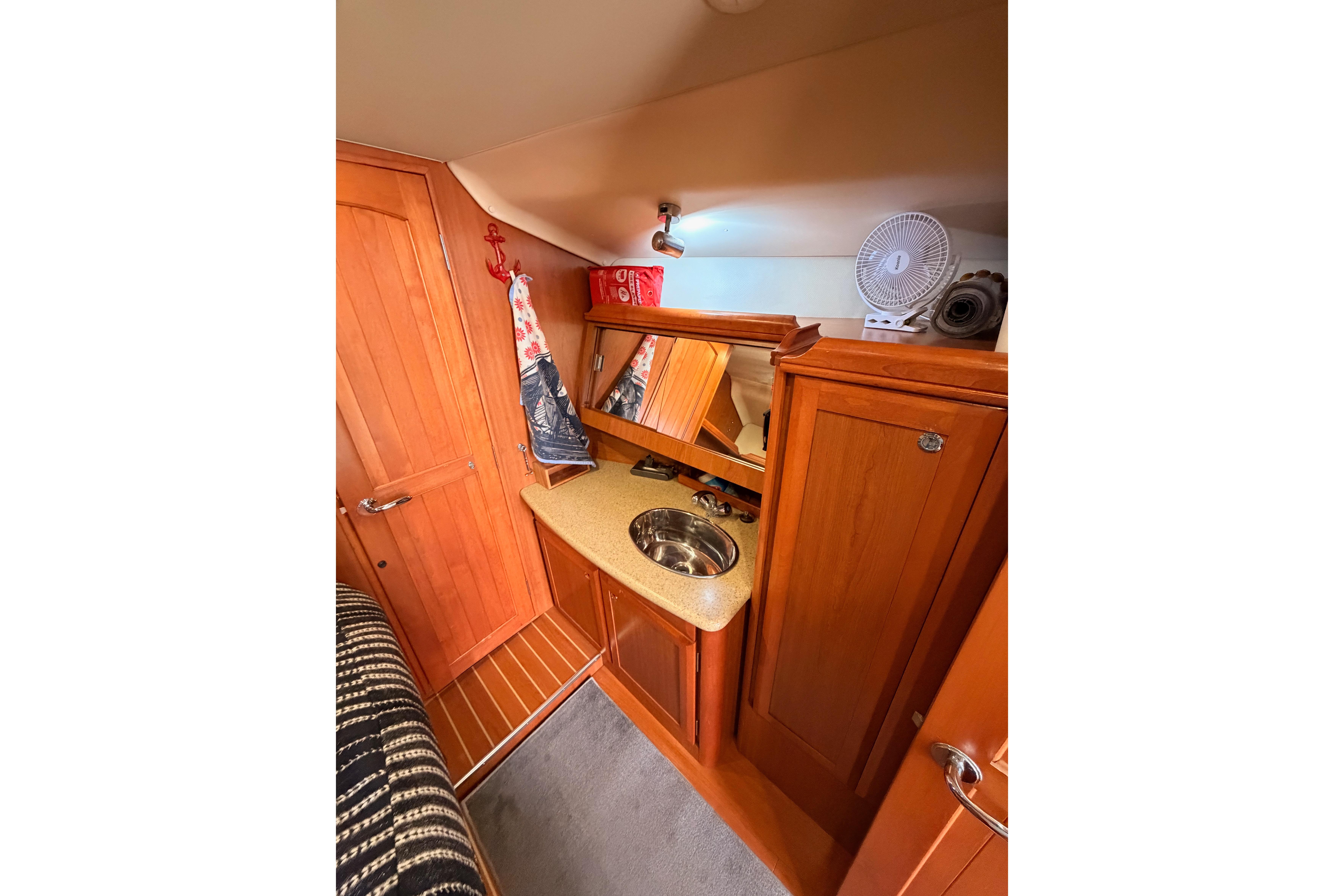 Interior of 2008 Hunter 45 Deck Salon with wooden cabinetry and compact sink area.