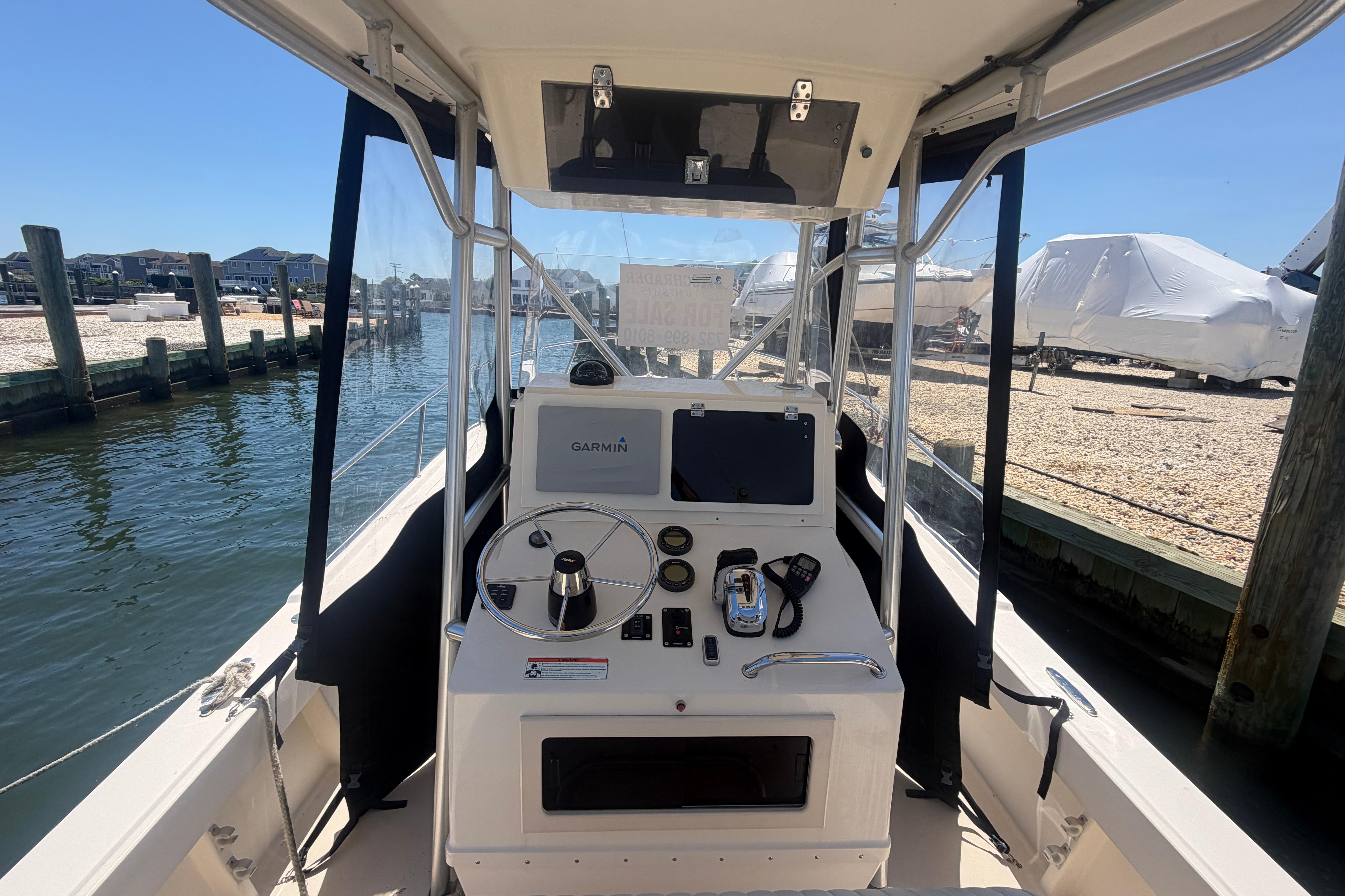 2006 Parker 23SE Center Console boat at dock with navigation equipment.