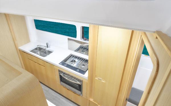 Modern kitchen interior of 2025 Seawind 1170 catamaran with ocean view.