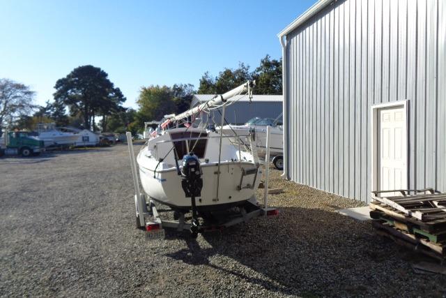 2007 Sanibel by International Marine 18 Pocket Cruiser on trailer near metal building.