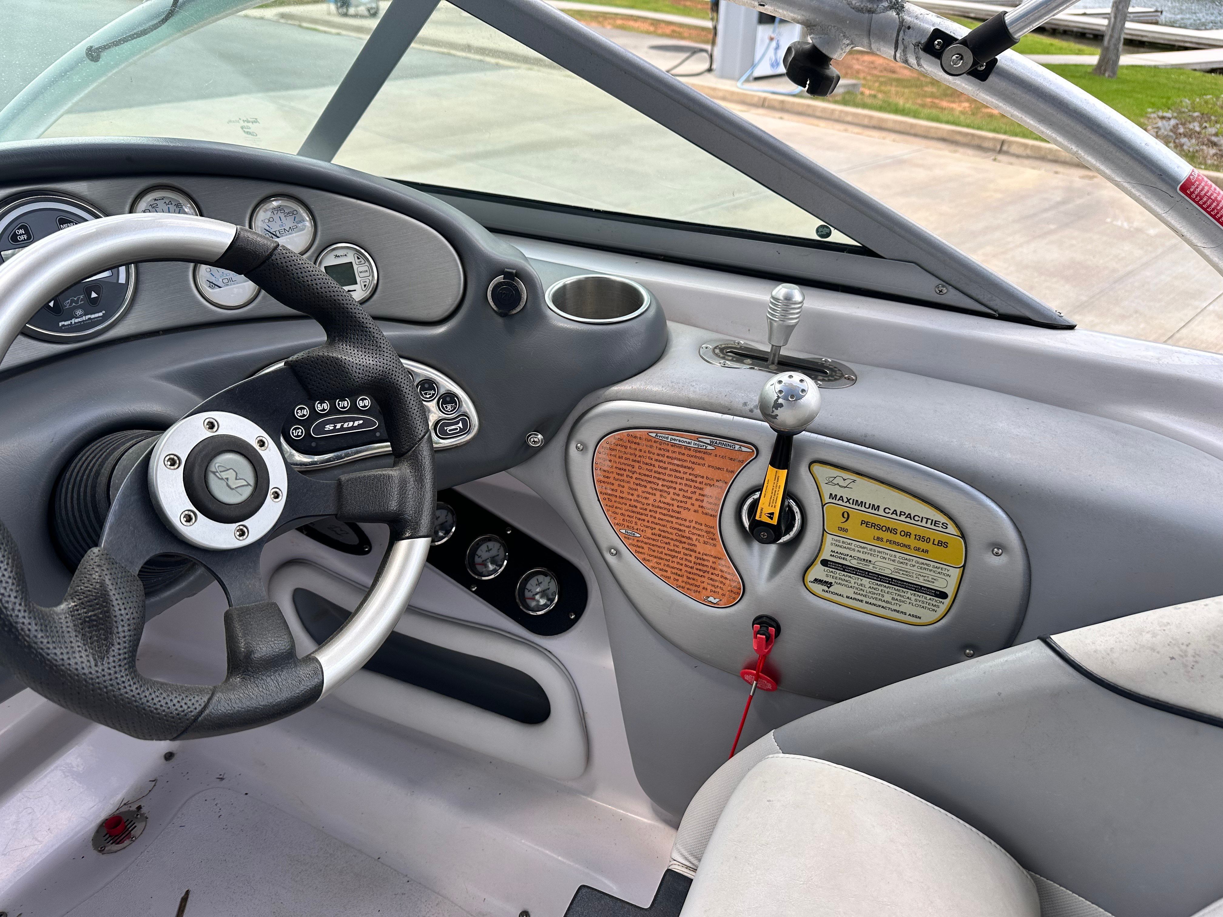 Interior view of a 2007 Nautique SV 211 with steering wheel and control console.