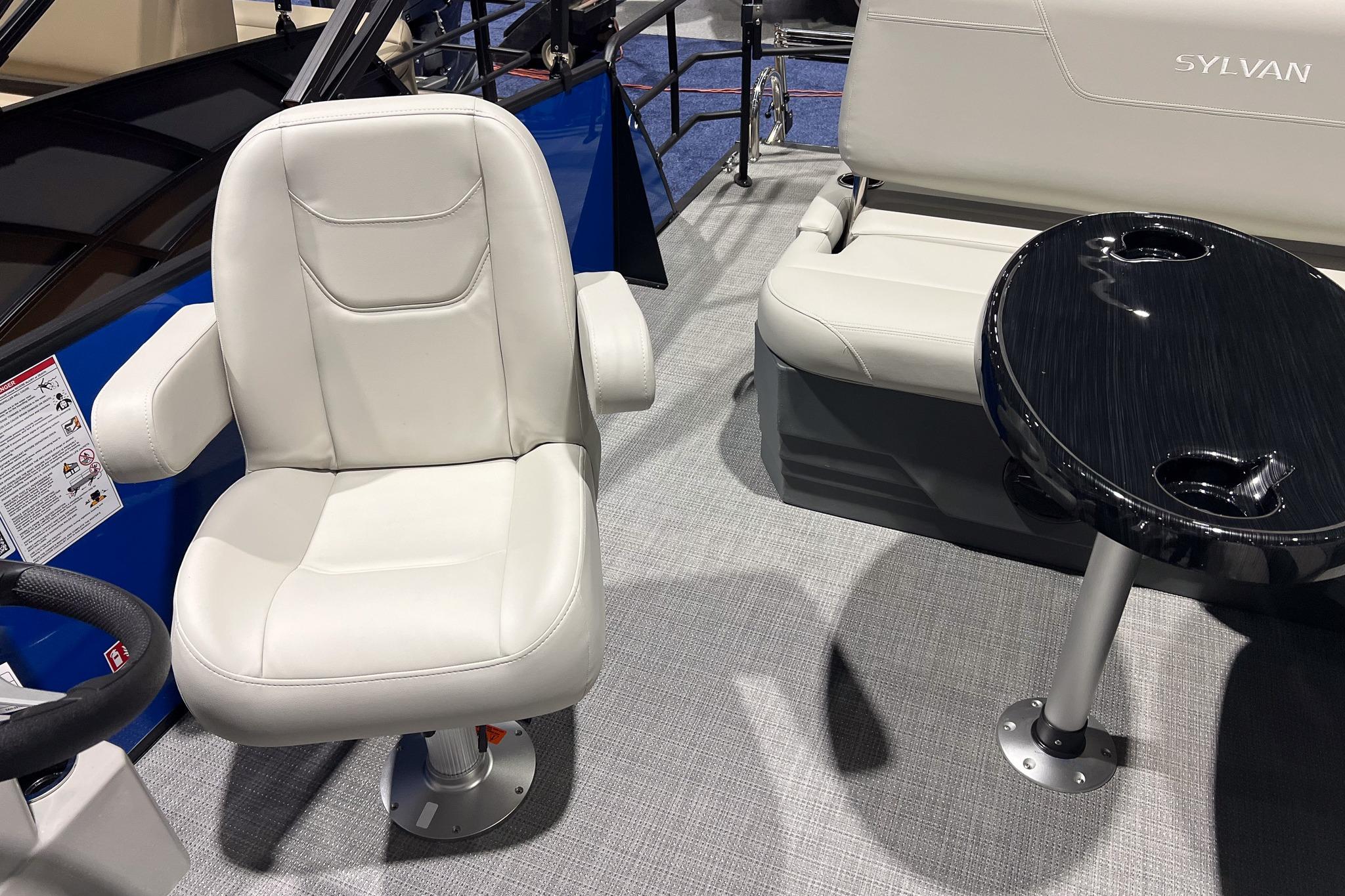 2026 Sylvan Mirage 822 CLZ boat interior with white seating and black table.