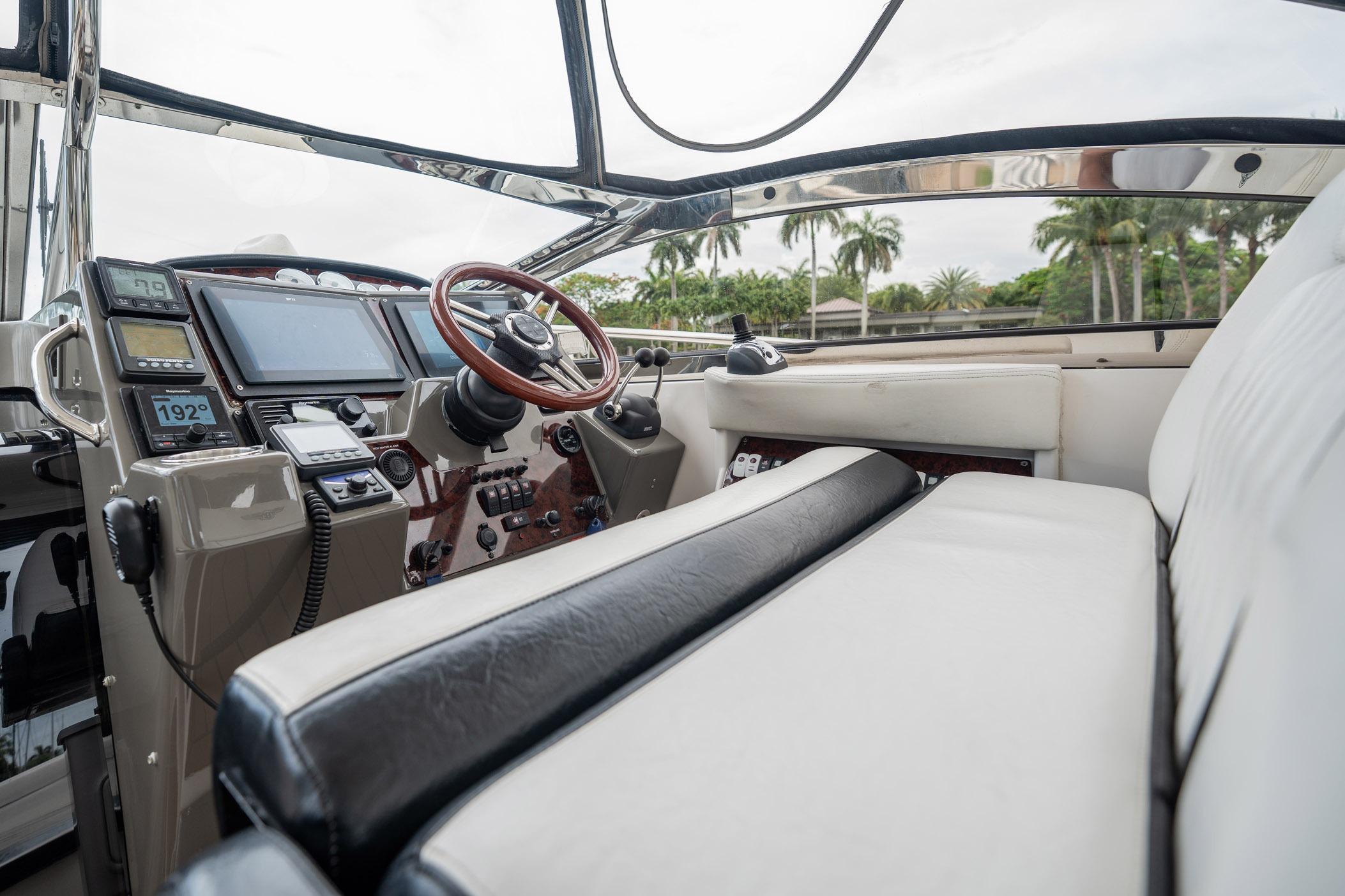2008 Regal Commodore 4460 yacht cockpit with leather seating and modern navigation controls.