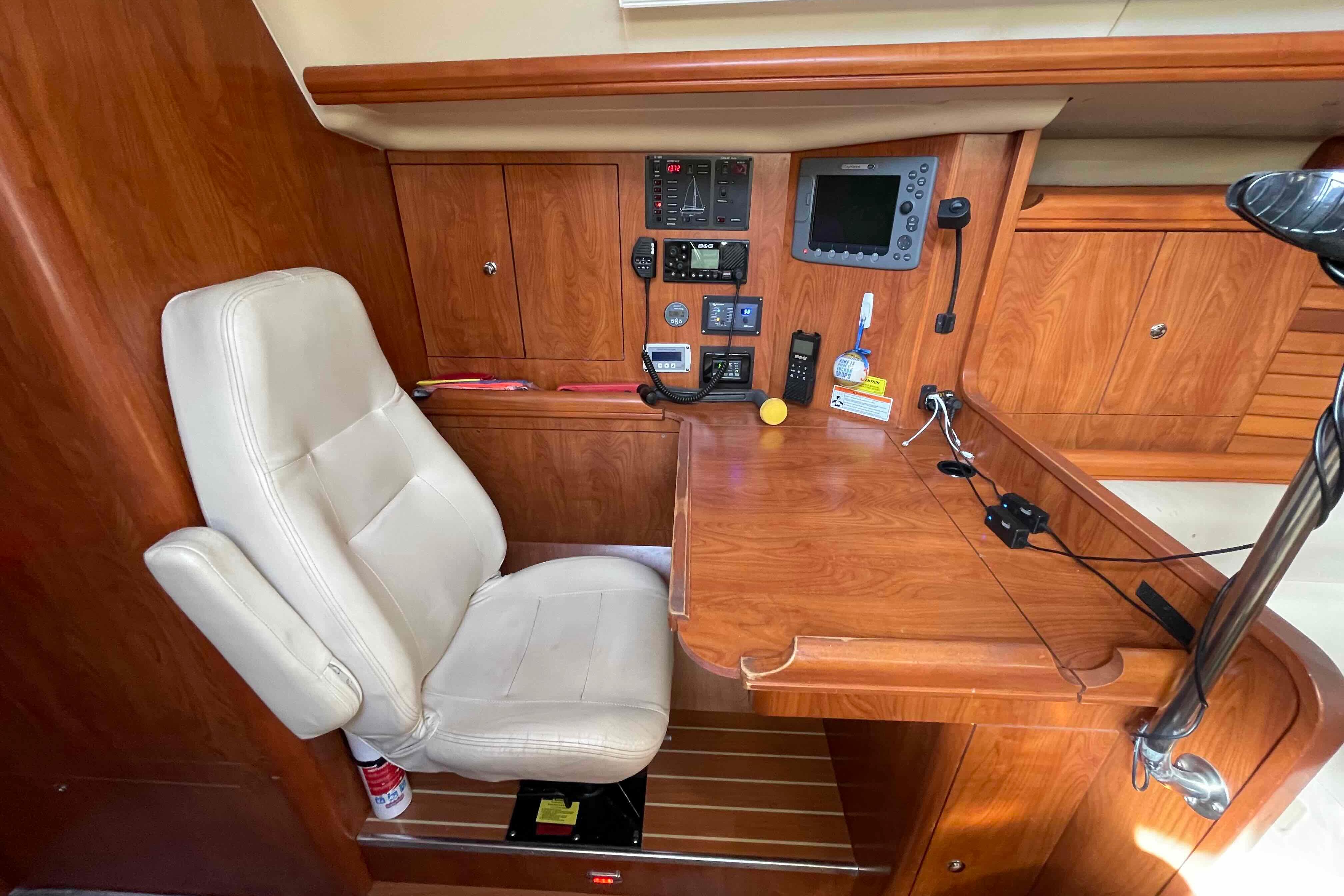 Luxurious 2010 Hunter 45 Center Cockpit interior with navigation station and plush seating.