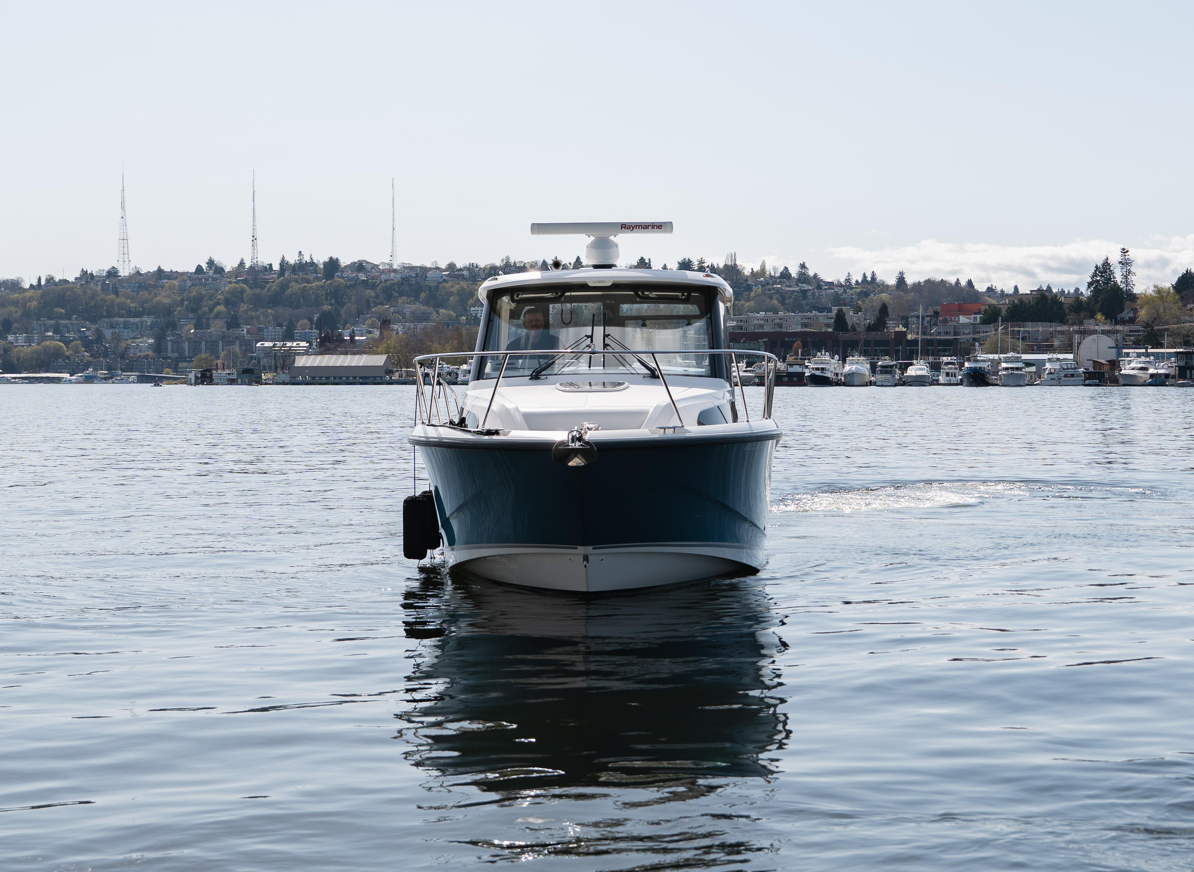 2020 Boston Whaler 325 Conquest Pilothouse on calm water, front view.