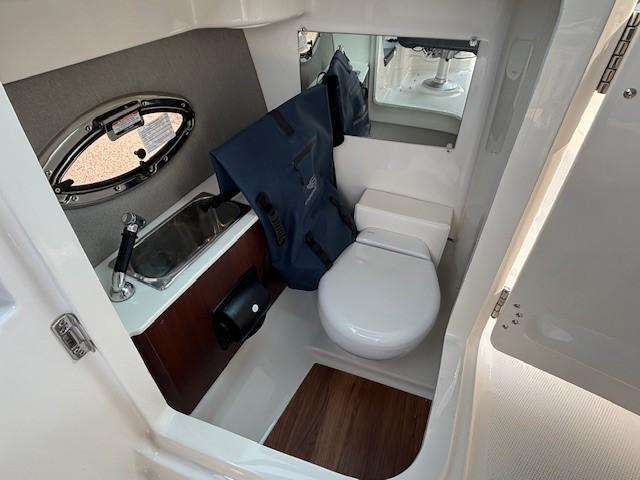 2026 Chaparral SSX 6 boat bathroom with sink, toilet, and mirror.