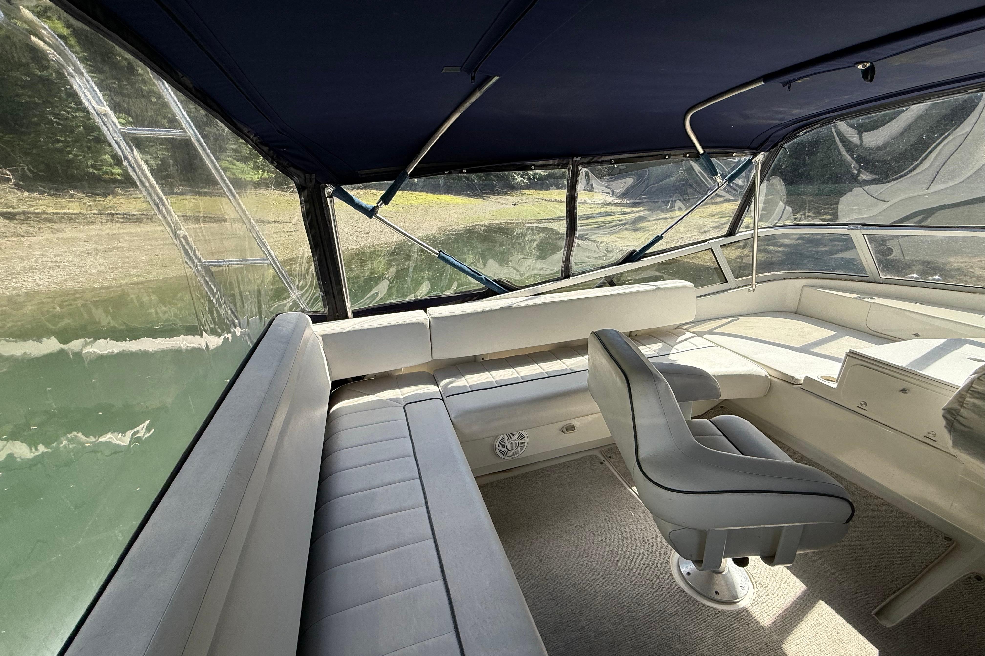 Interior view of a 1995 Carver 370 Voyager boat with seating and helm.