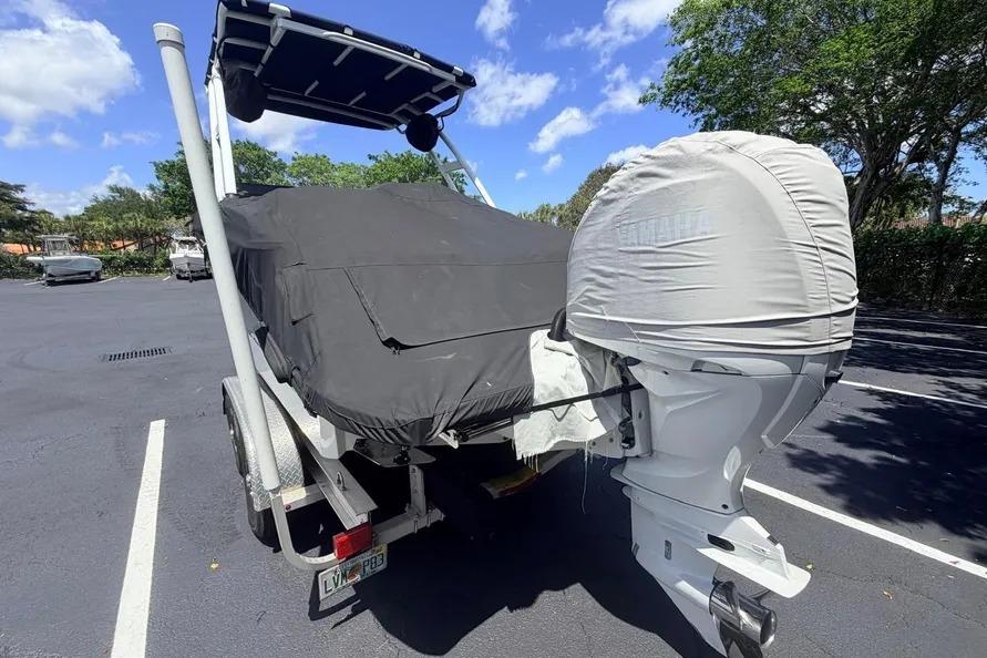 2022 Cobalt R6 Outboard boat covered, parked in a sunny lot.