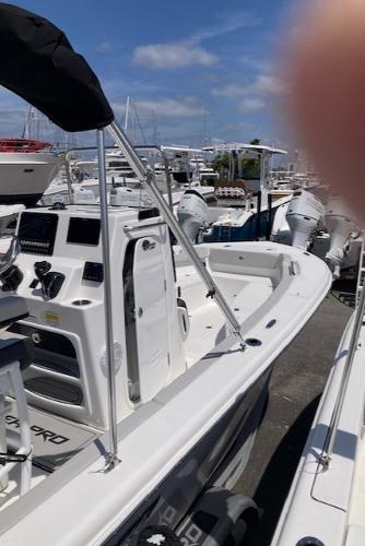 2025 Sea Pro 202 Center Console boat docked, featuring modern controls and dual engines.
