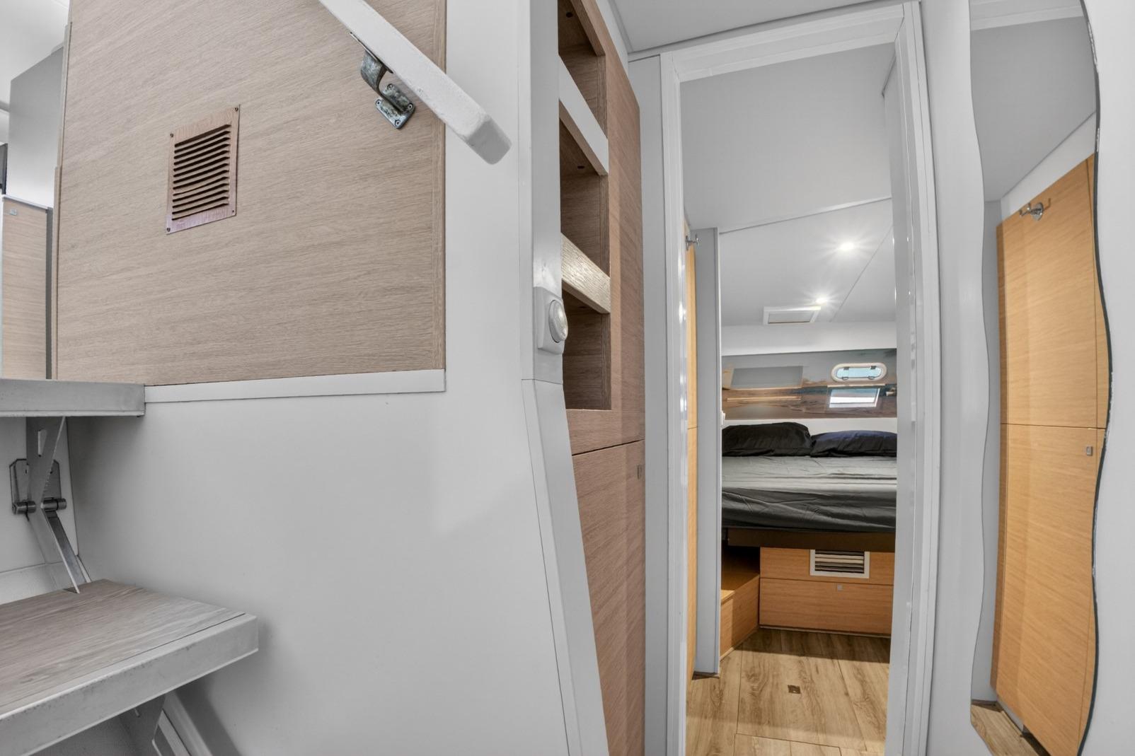 Interior of 2015 Catana BALI 4.5 yacht, featuring a cozy bedroom and modern wooden finishes.