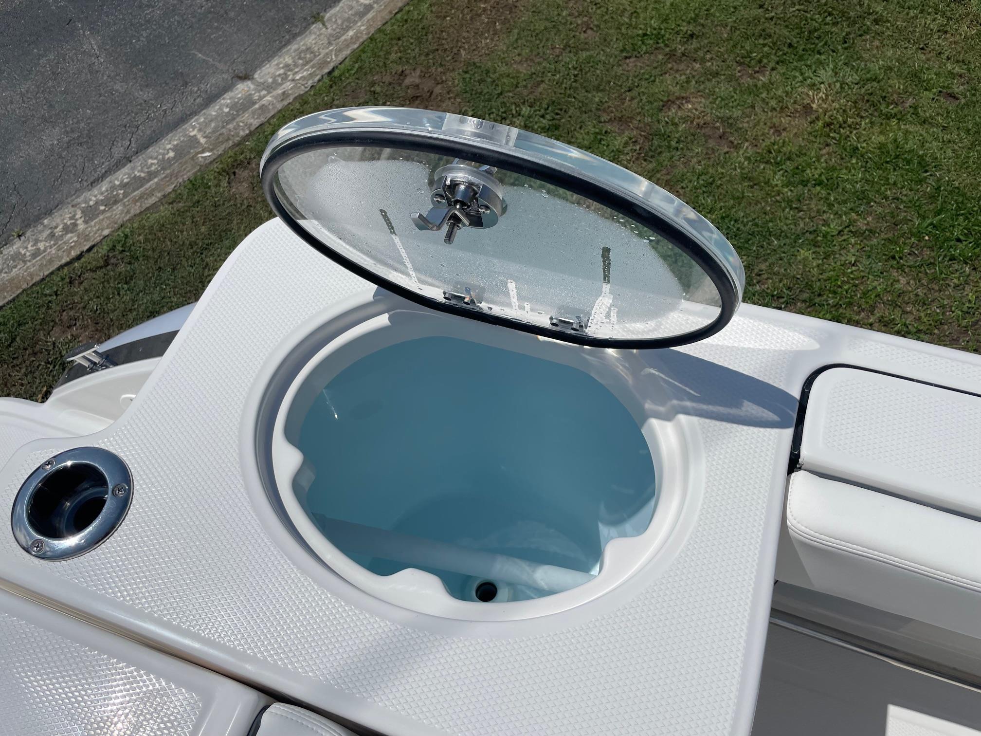 2025 Robalo R230 Center Console livewell with open lid, showcasing interior design.