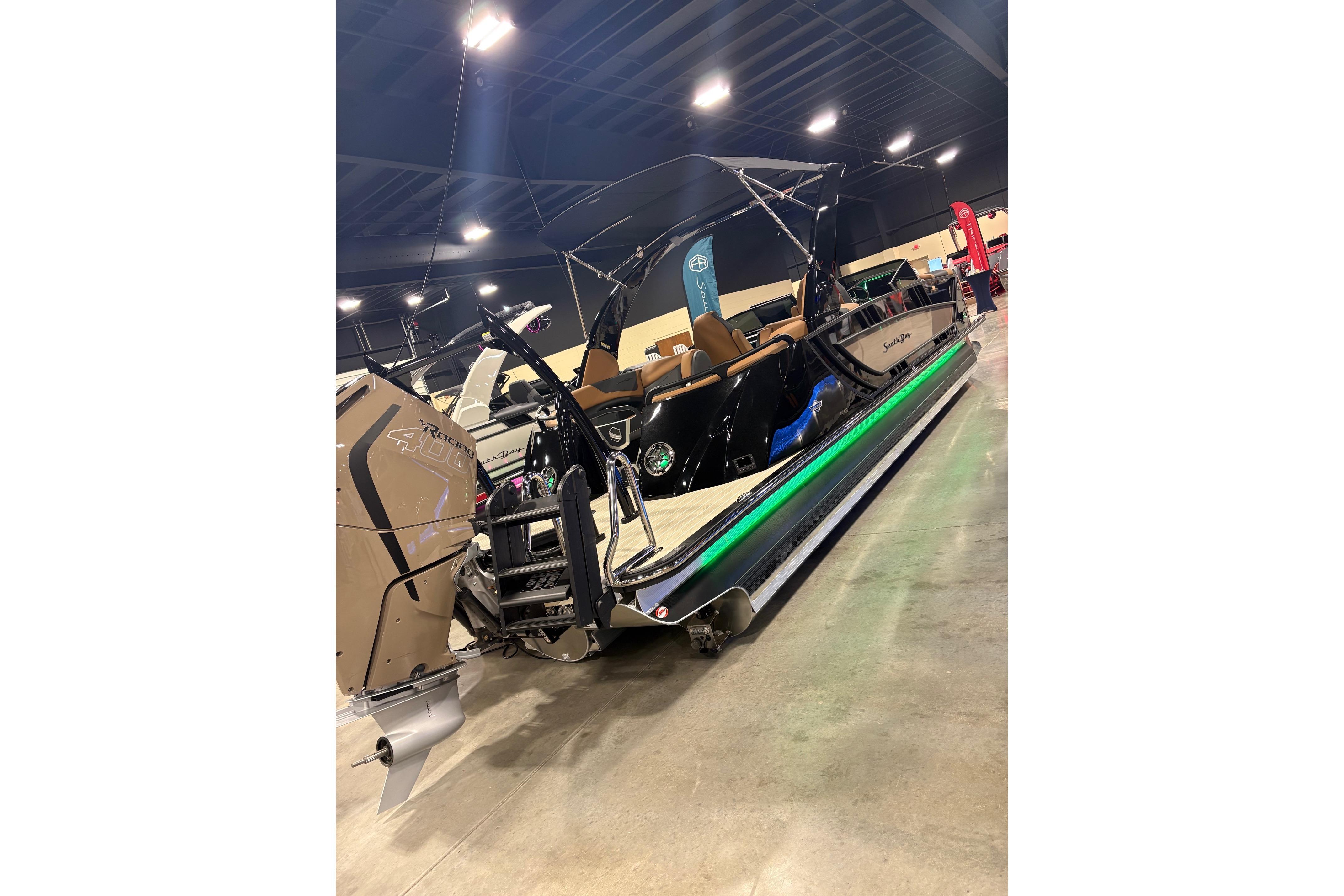 2026 South Bay Sport RS9 DC boat displayed indoors with vibrant lighting.