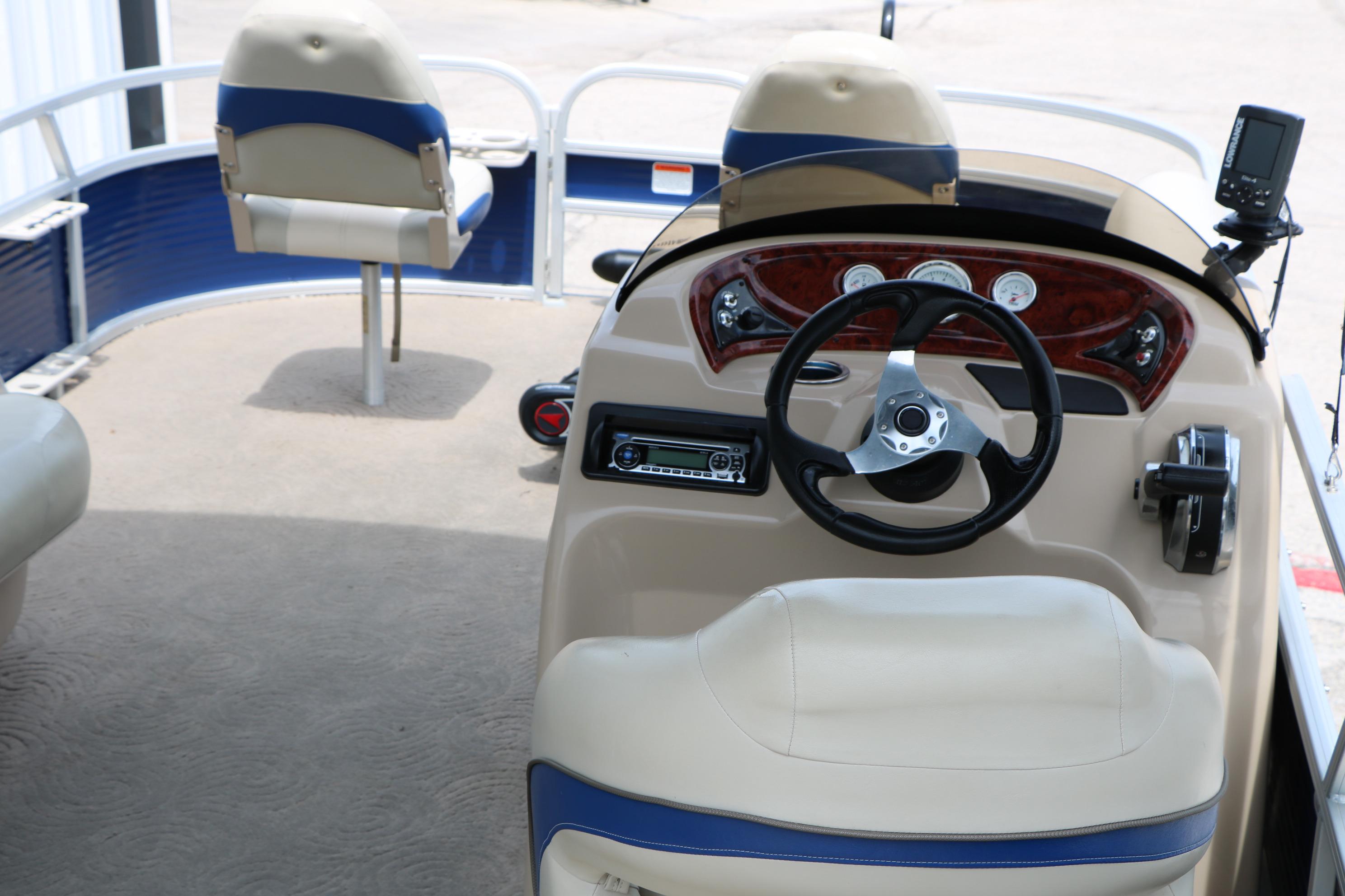 2013 Sun Tracker Fishin' Barge 20 DLX interior with steering wheel and seating.