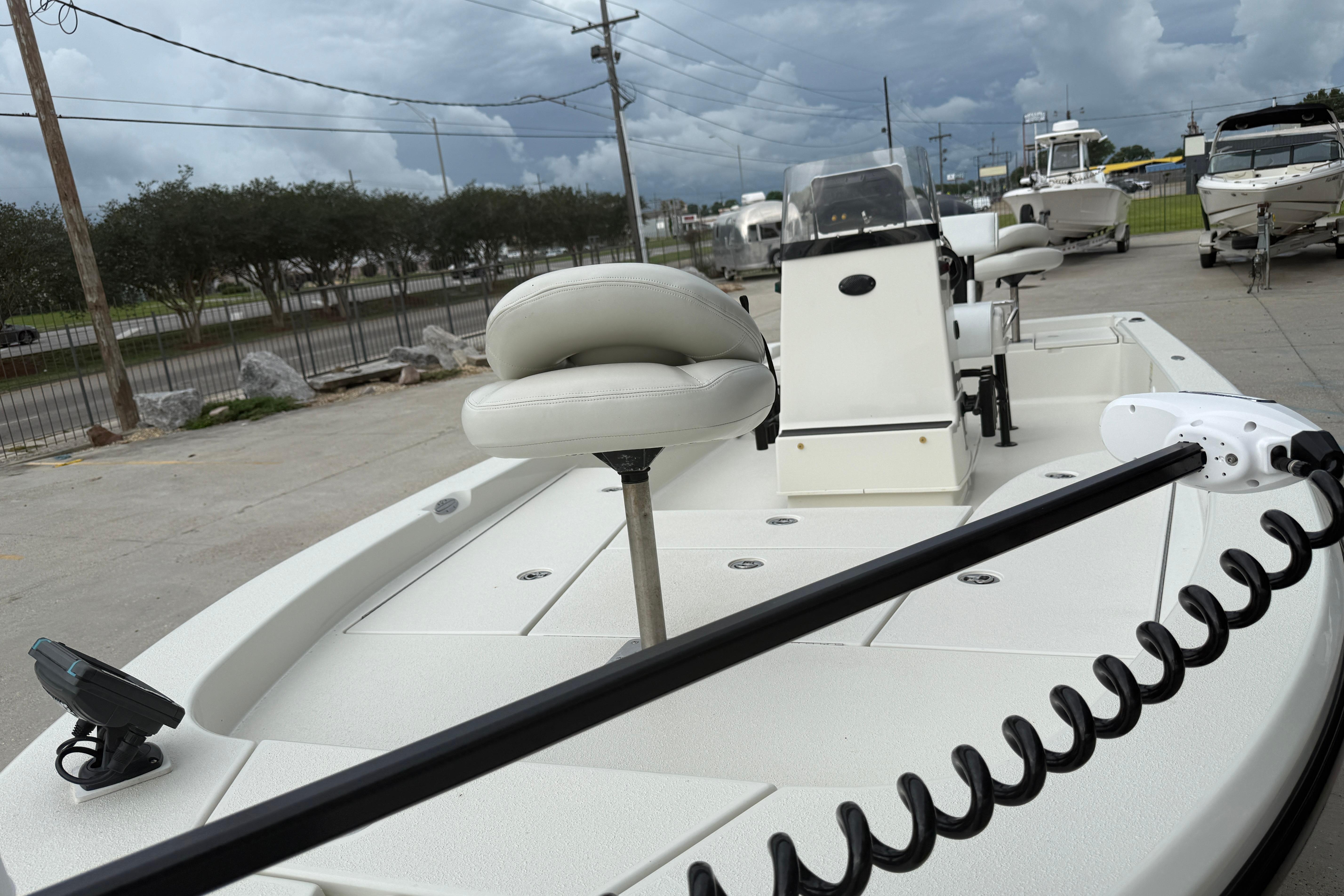 2007 Ranger 2200 Bay Ranger boat with seating and control panel, parked outdoors.