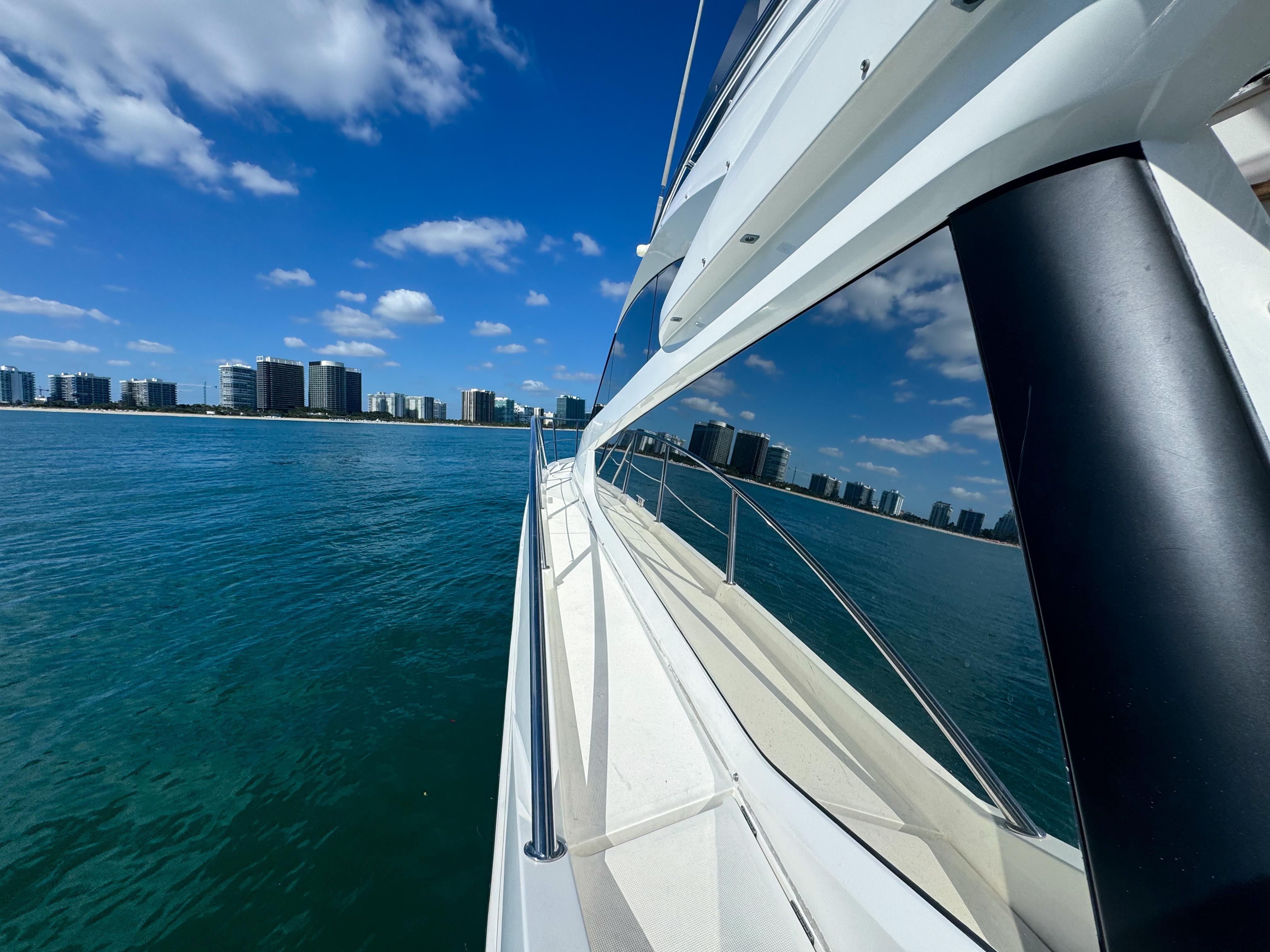 Galeon 420 Fly yacht cruising near city skyline, 2016 model.