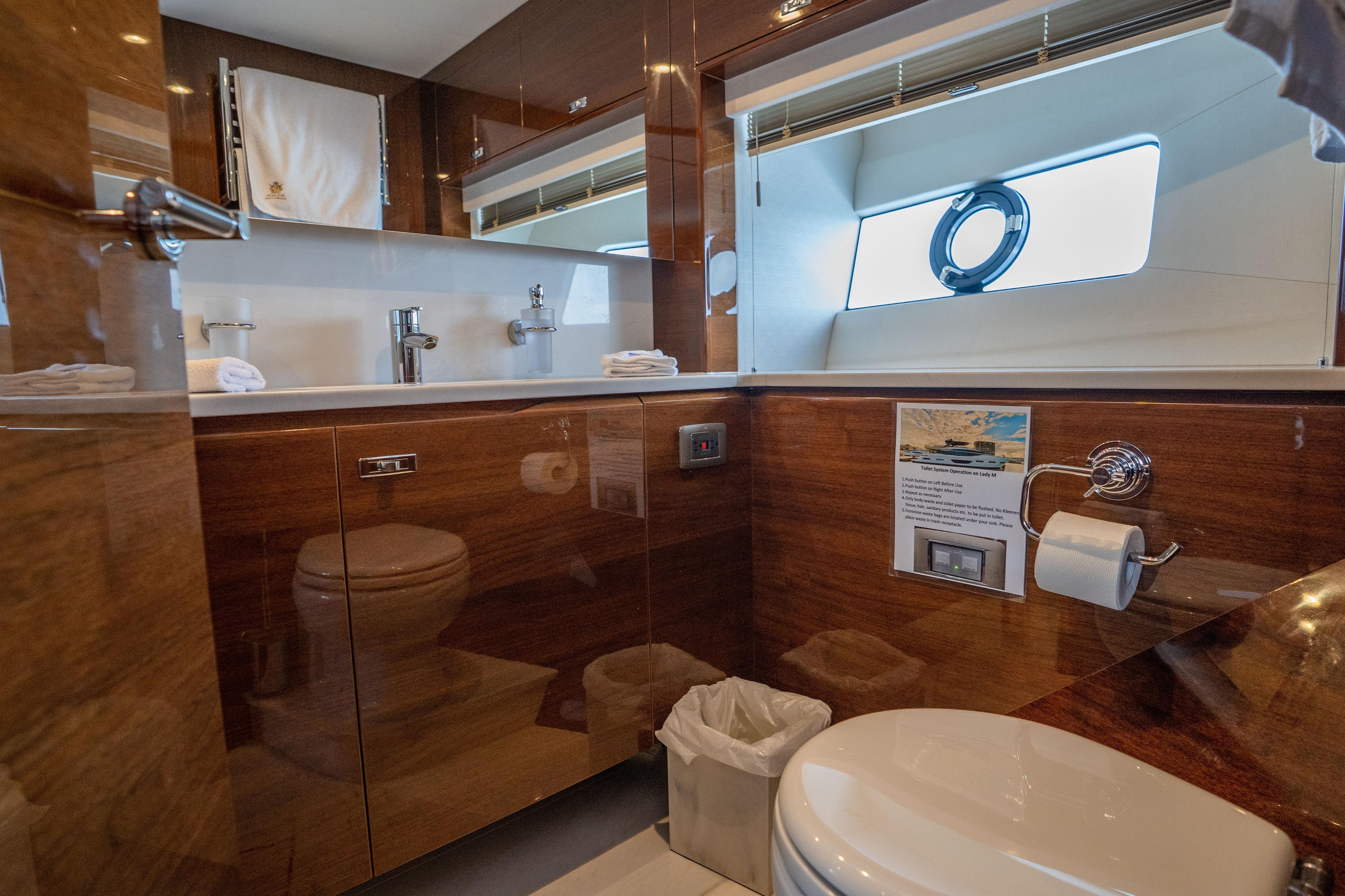 Luxurious bathroom interior on a 2020 Princess Y85 yacht, featuring elegant wood finishes.