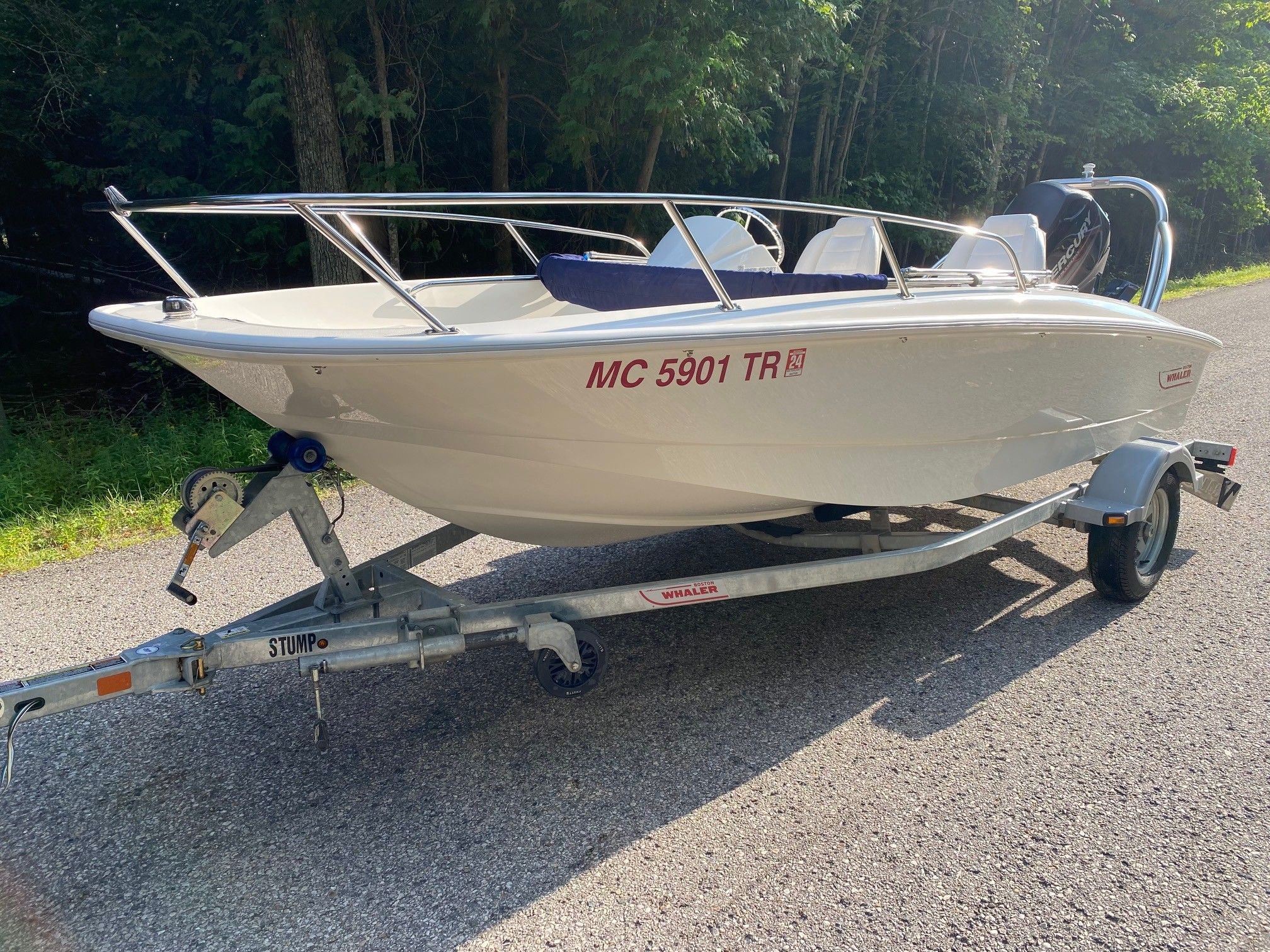2013 Boston Whaler 150 Super Sport on trailer outdoors.