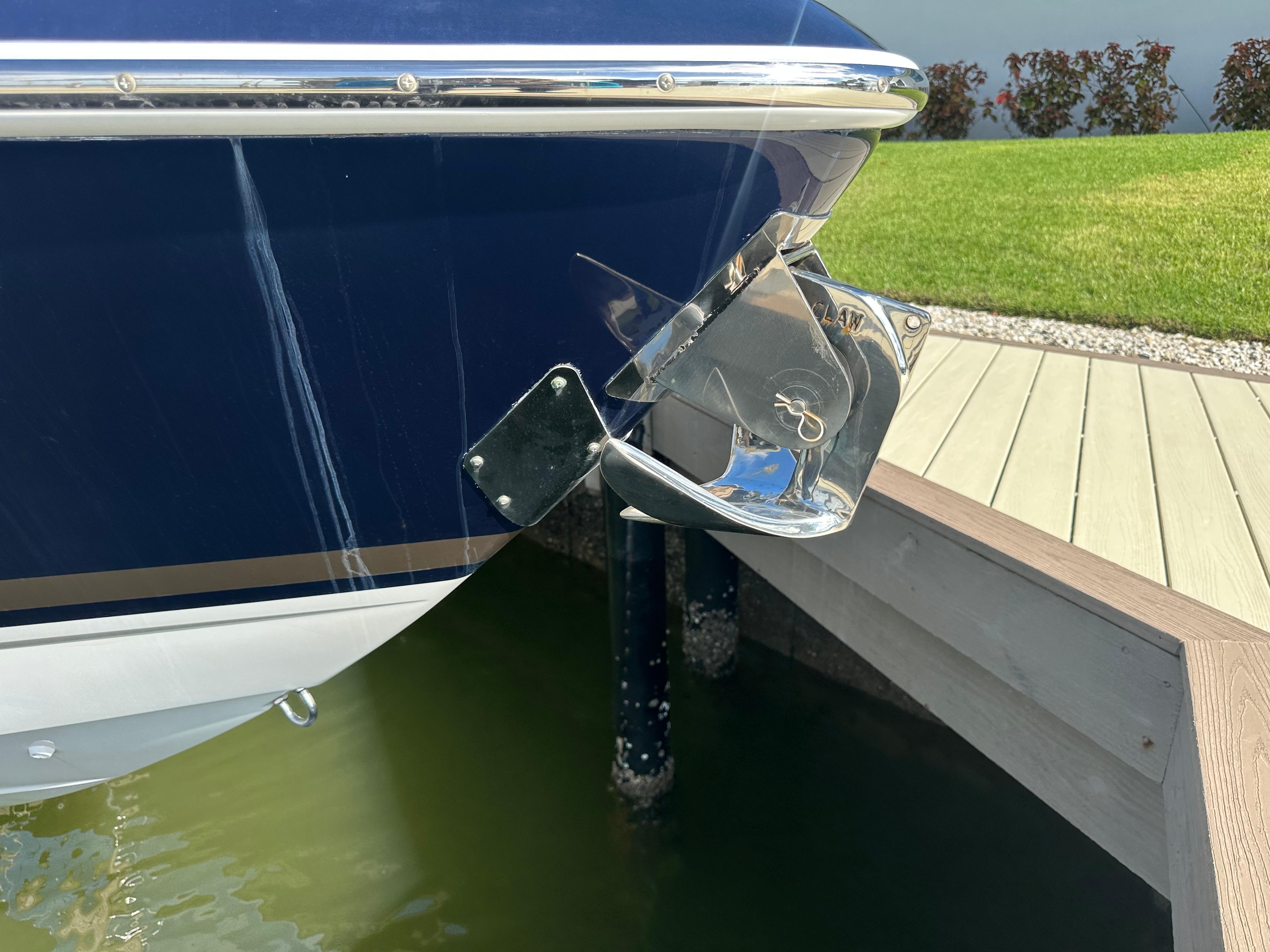 2015 Formula 310 Bowrider boat anchored at dockside, close-up view.