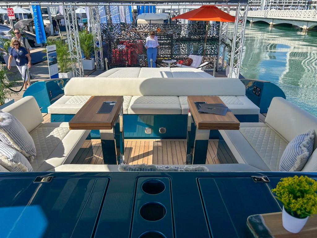 2024 Solaris Power 52 Open luxury yacht interior with seating and tables at a marina.