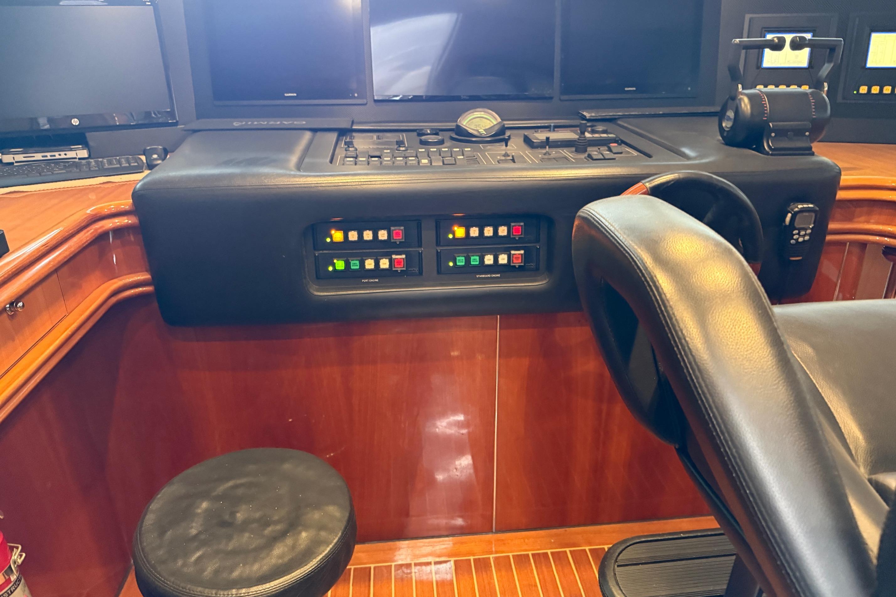 Control panel of a 2002 Sunseeker 105 Yacht with leather seating and wooden accents.