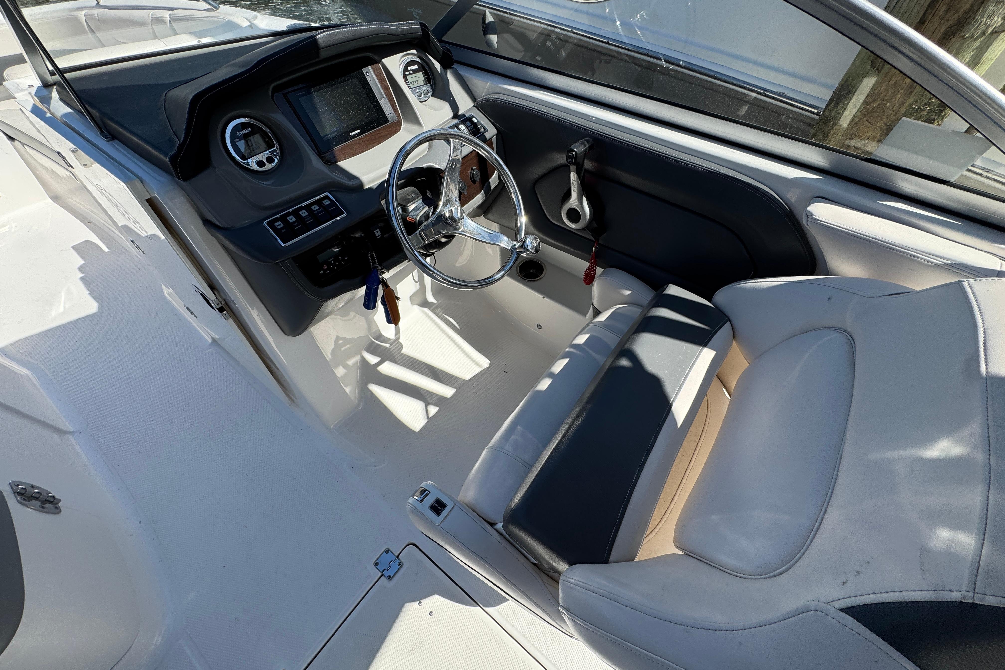 2018 Chaparral 250 Suncoast boat cockpit with steering wheel and dashboard controls.