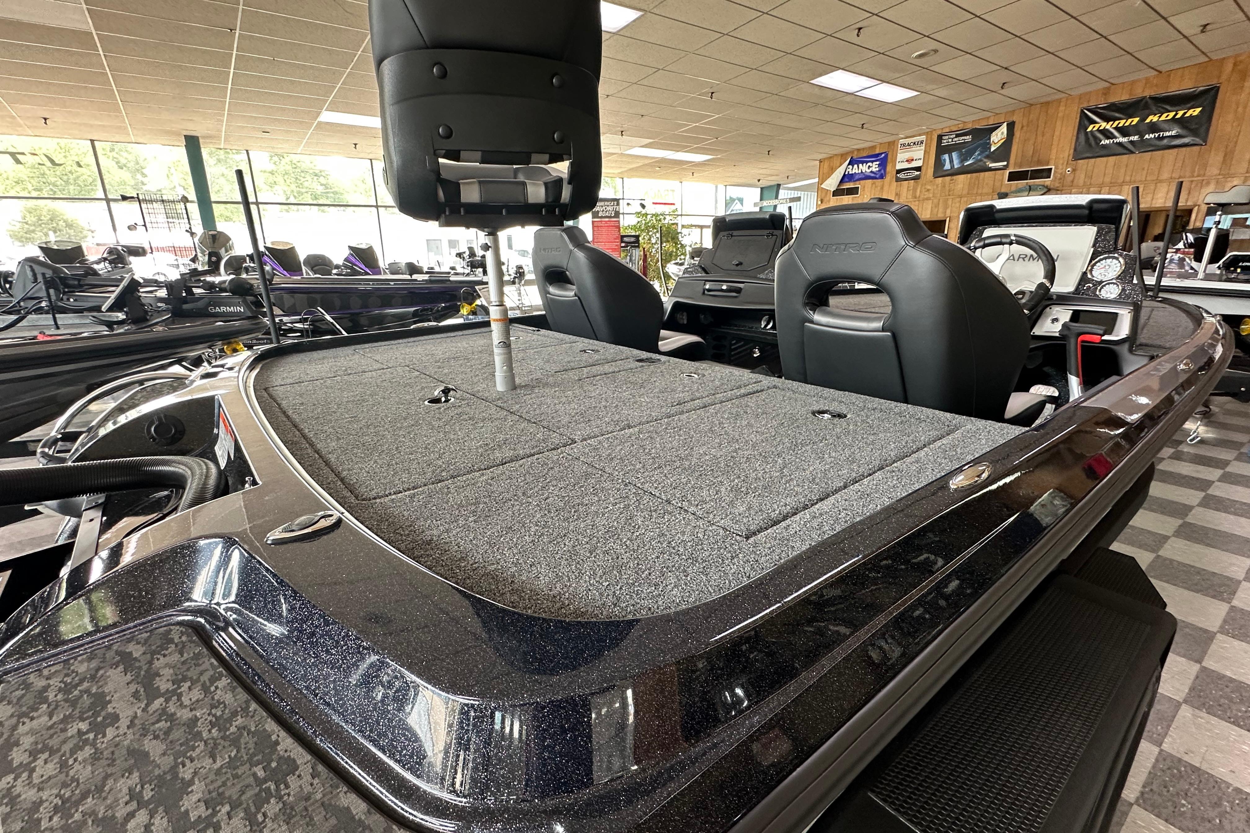 2025 Nitro Z20 XL Pro boat interior with seating and storage in showroom.