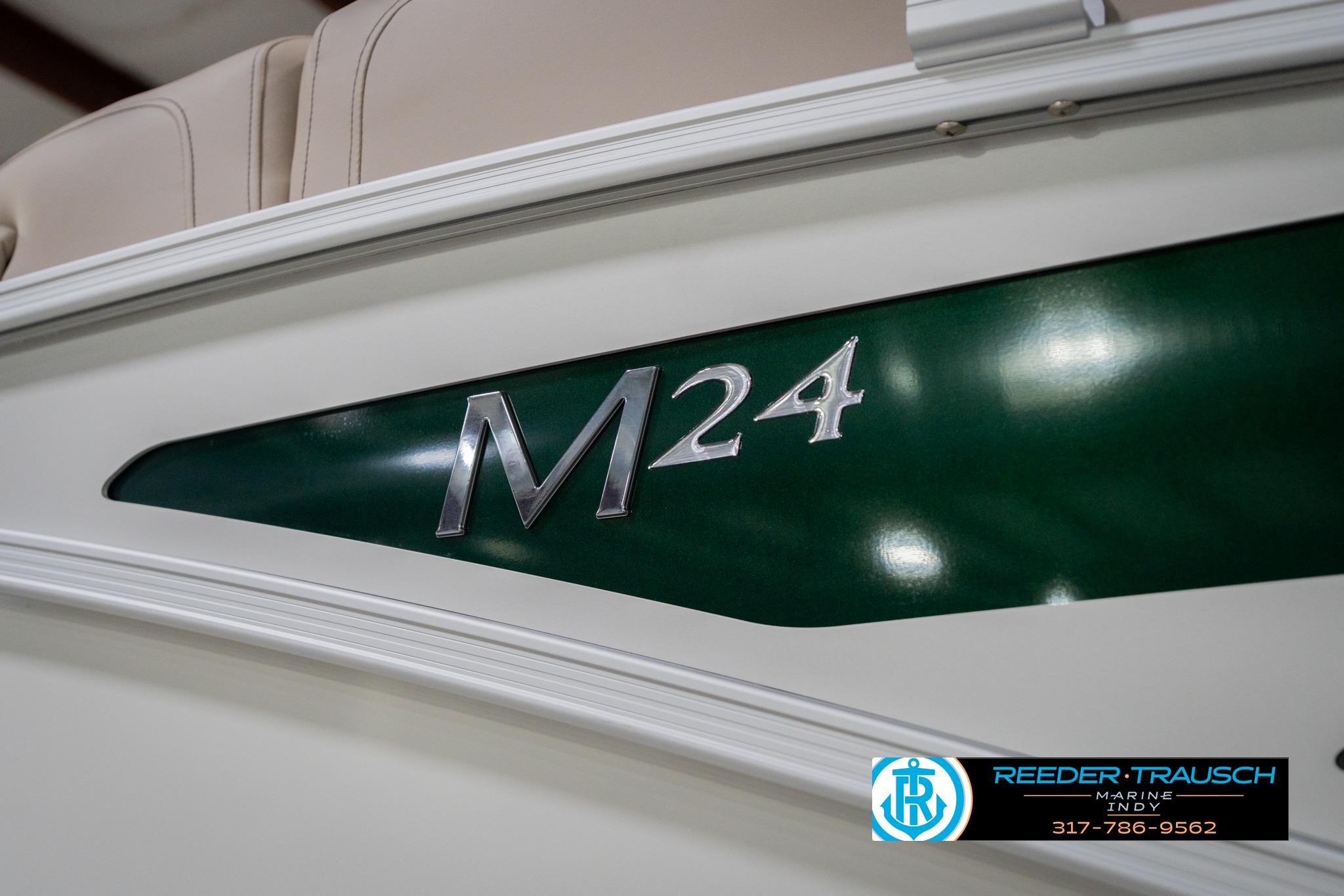 2026 Bennington 24 MFB boat, green and white design, Reeder Trausch Marine logo.