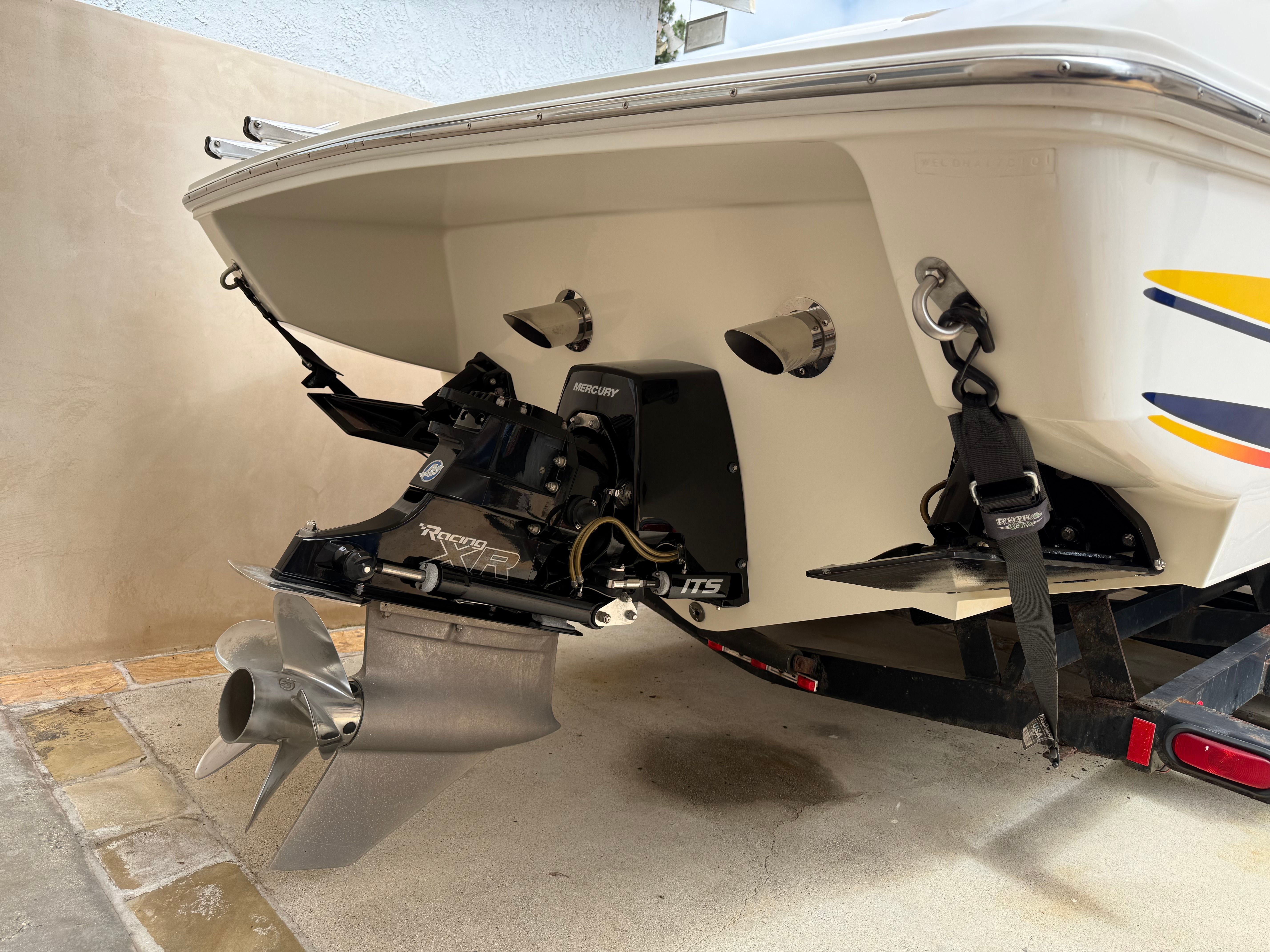 Rear view of a 2001 Wellcraft 29 Scarab boat with Mercury Racing engine.