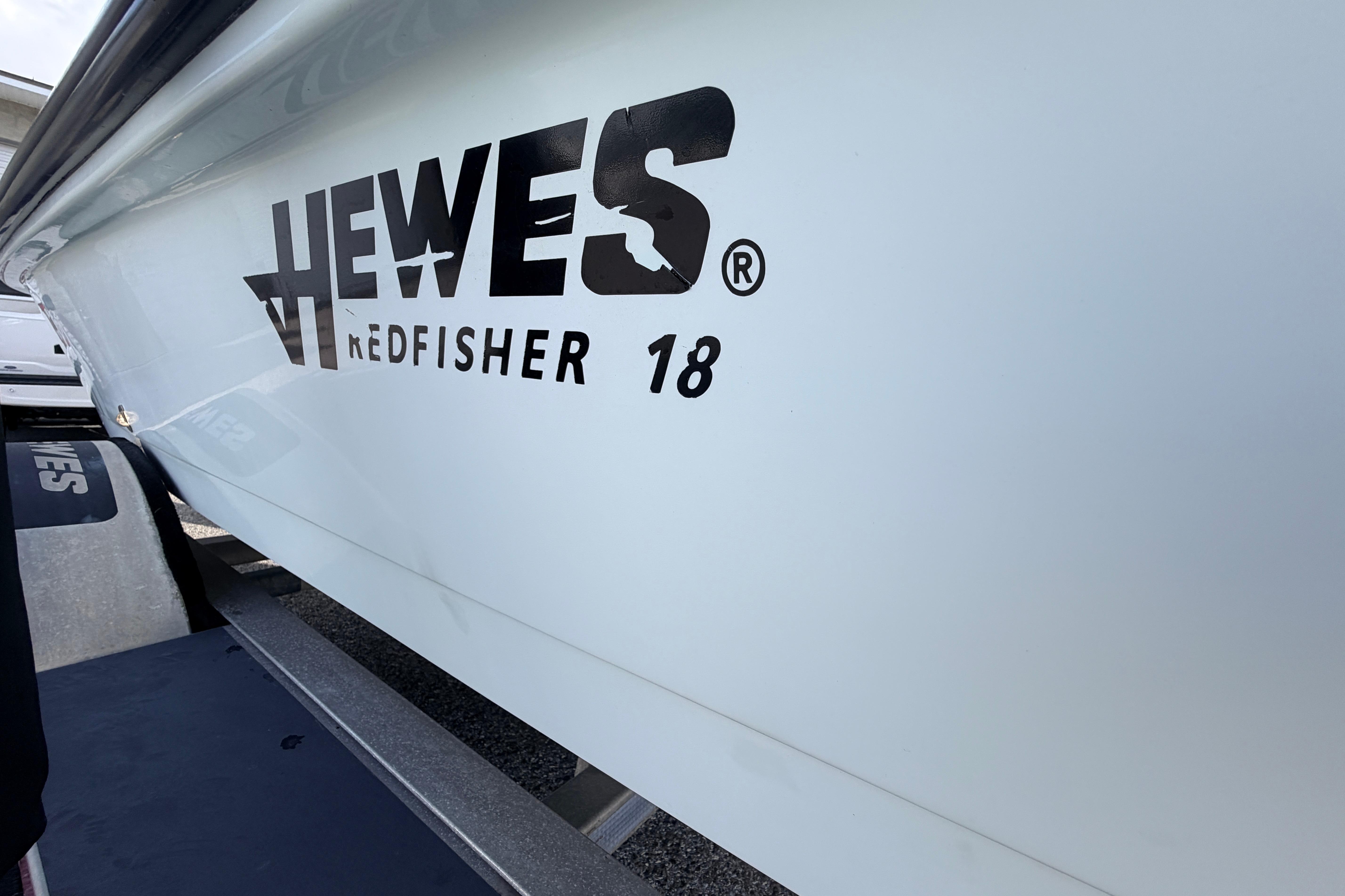 2004 Hewes Redfisher 18 boat side view with logo and trailer.