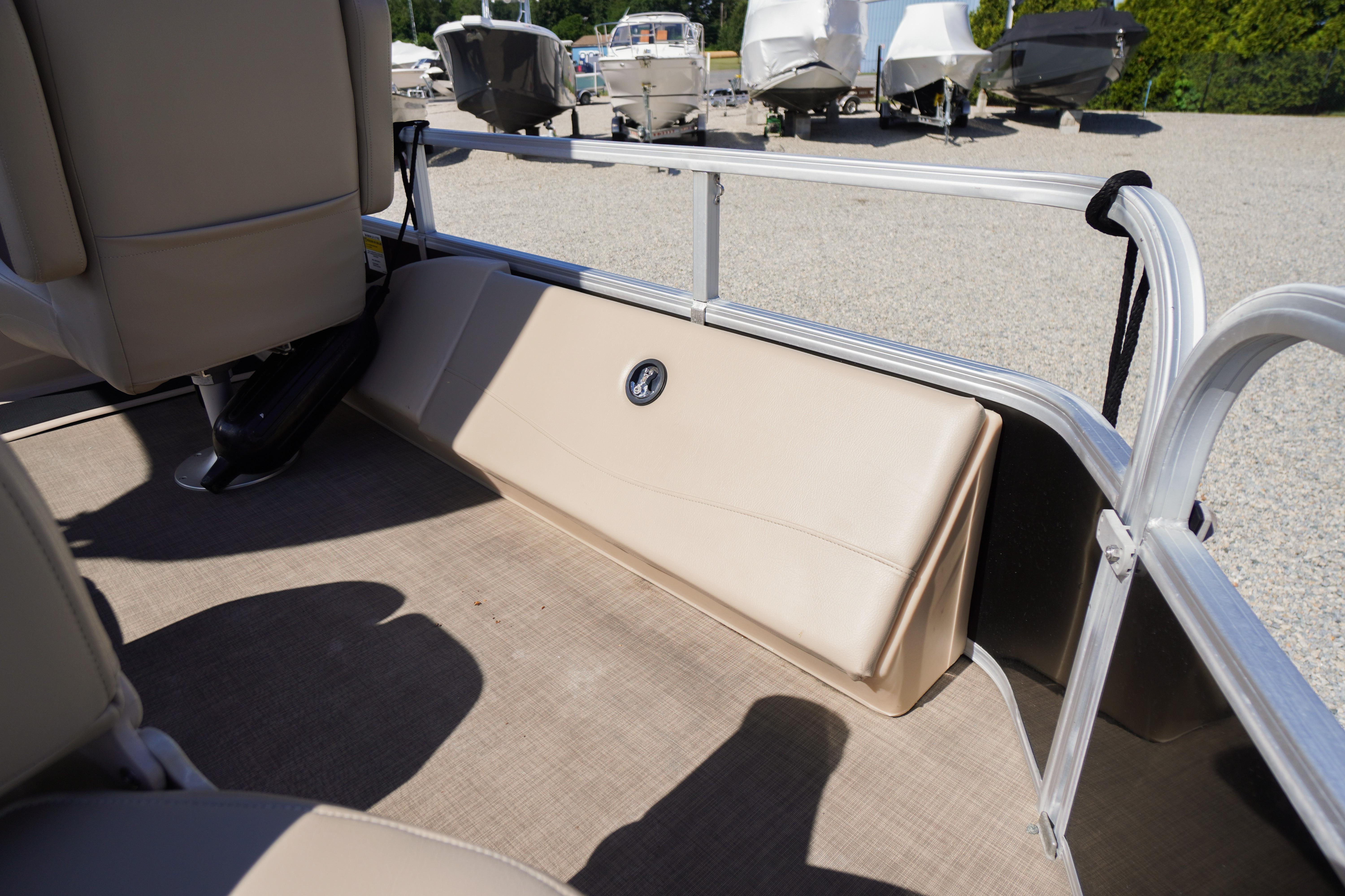 2019 SUNTRACKER Fishin' Barge 22 DLX interior with beige seating and railing.
