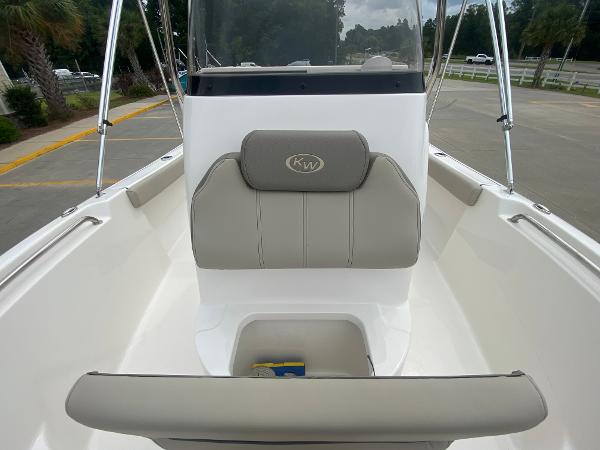 2024 Key West 189 FS boat interior with cushioned seating and storage compartment.