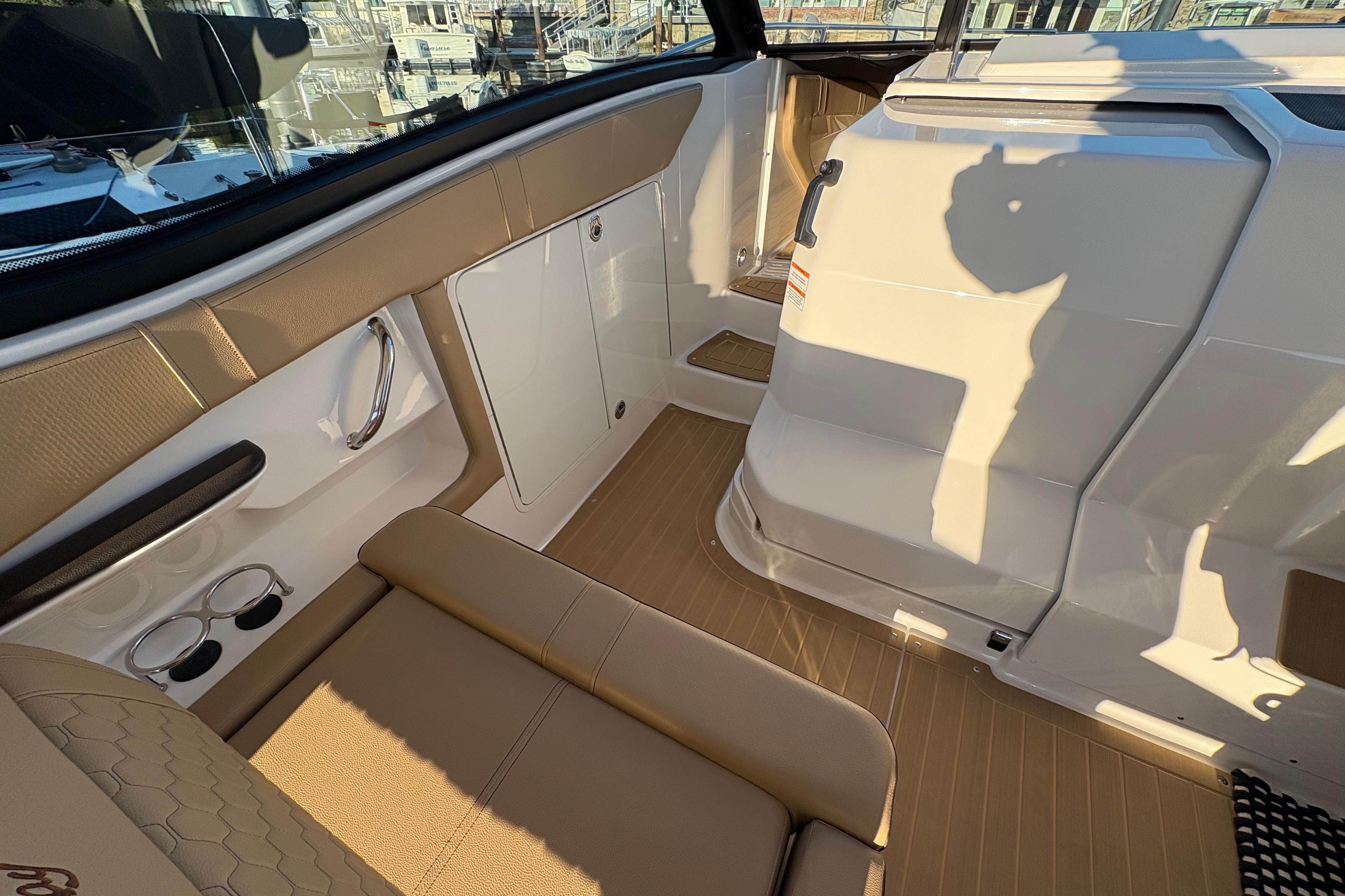Interior of 2022 Sea Ray Sundancer 320, featuring beige seating and sleek design elements.