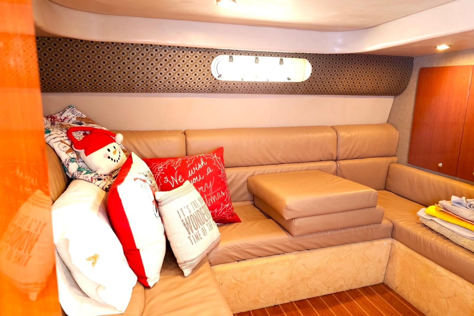 2004 Formula 40 Performance Cruiser interior with cozy seating and festive pillows.