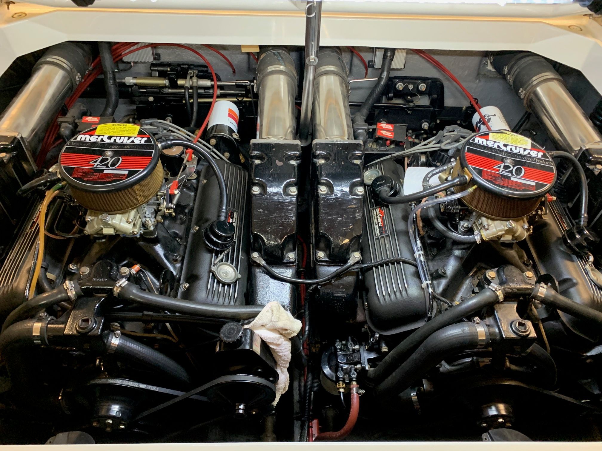 The engine compartment of a 1988 Formula 311 SR1 with dual powerful engines and tidy wiring.