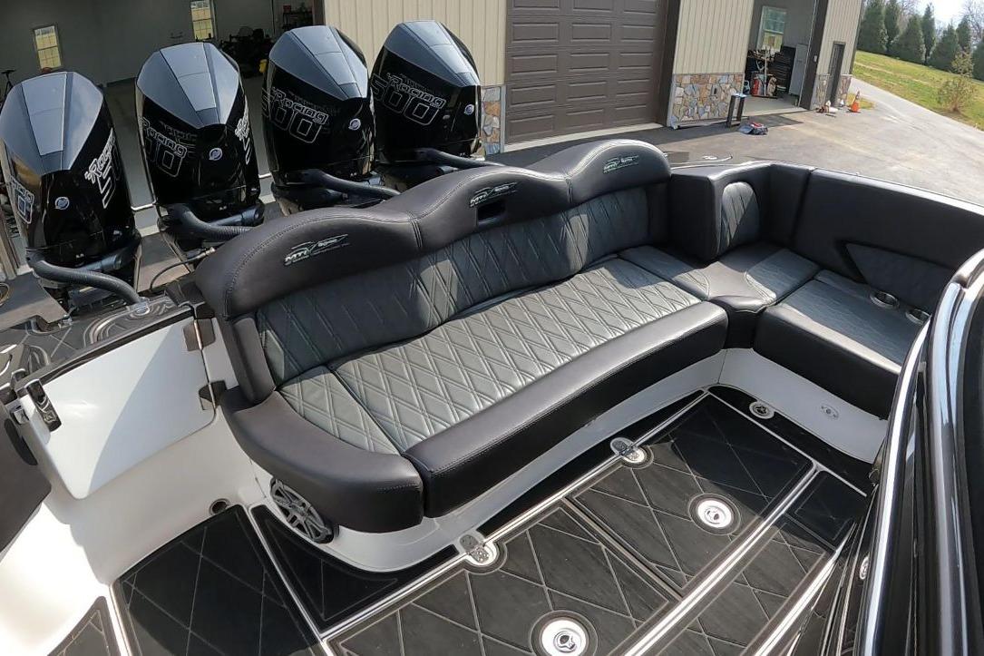 Luxurious 2018 MTI V42 boat interior with plush seating and powerful outboard engines.