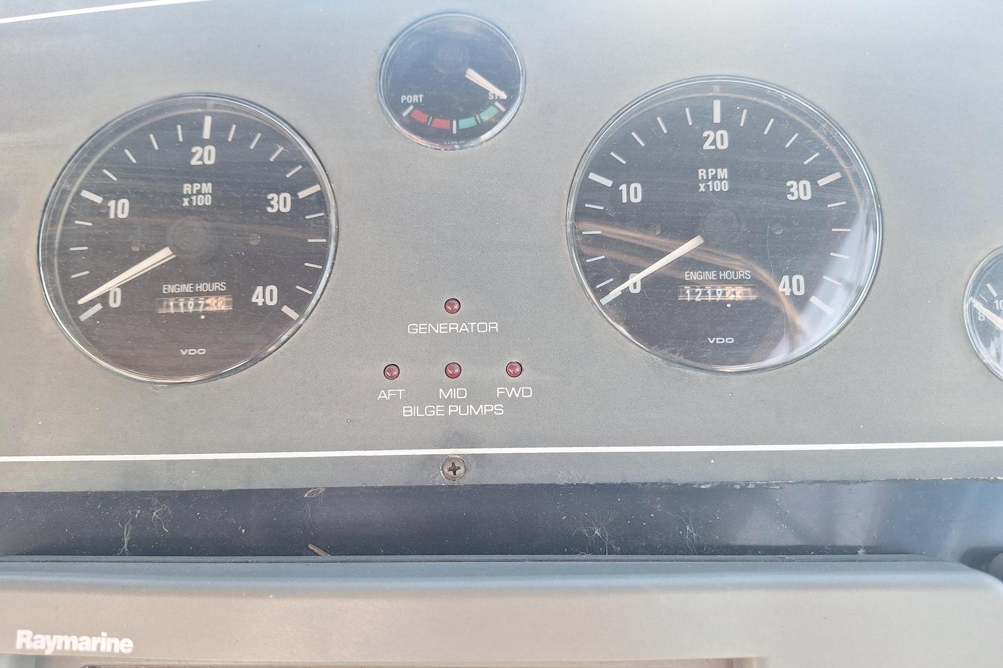 Dashboard of 2002 Tiara 3500 Open boat with RPM gauges and bilge pump indicators.