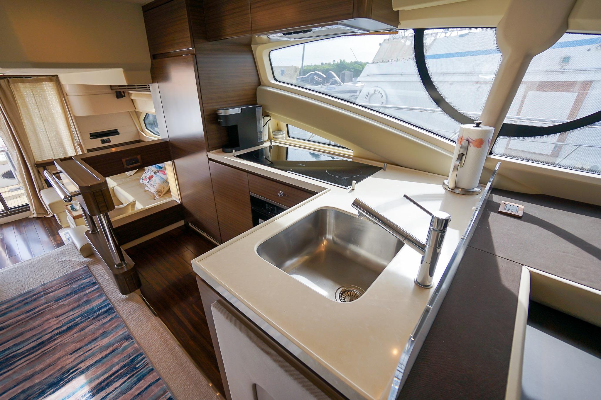 Luxurious interior of 2014 Azimut 54 Flybridge yacht with modern kitchen and seating area.