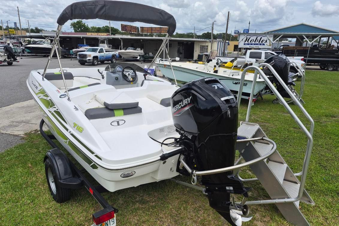 2021 Tahoe T16 boat with Mercury 75 engine on trailer, parked outdoors.