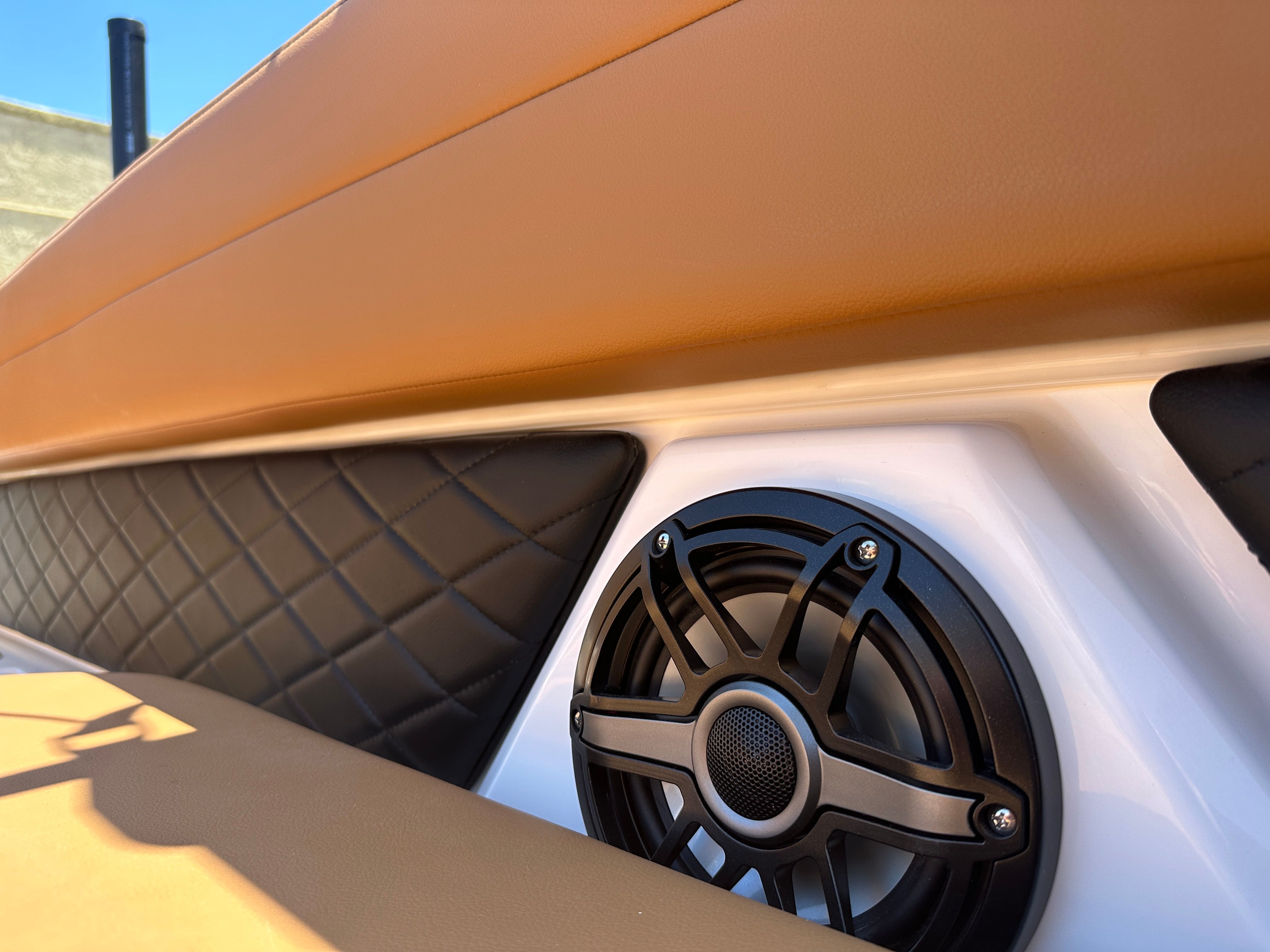 Close-up of a speaker and upholstered area on a Chaparral 26 Surf boat.