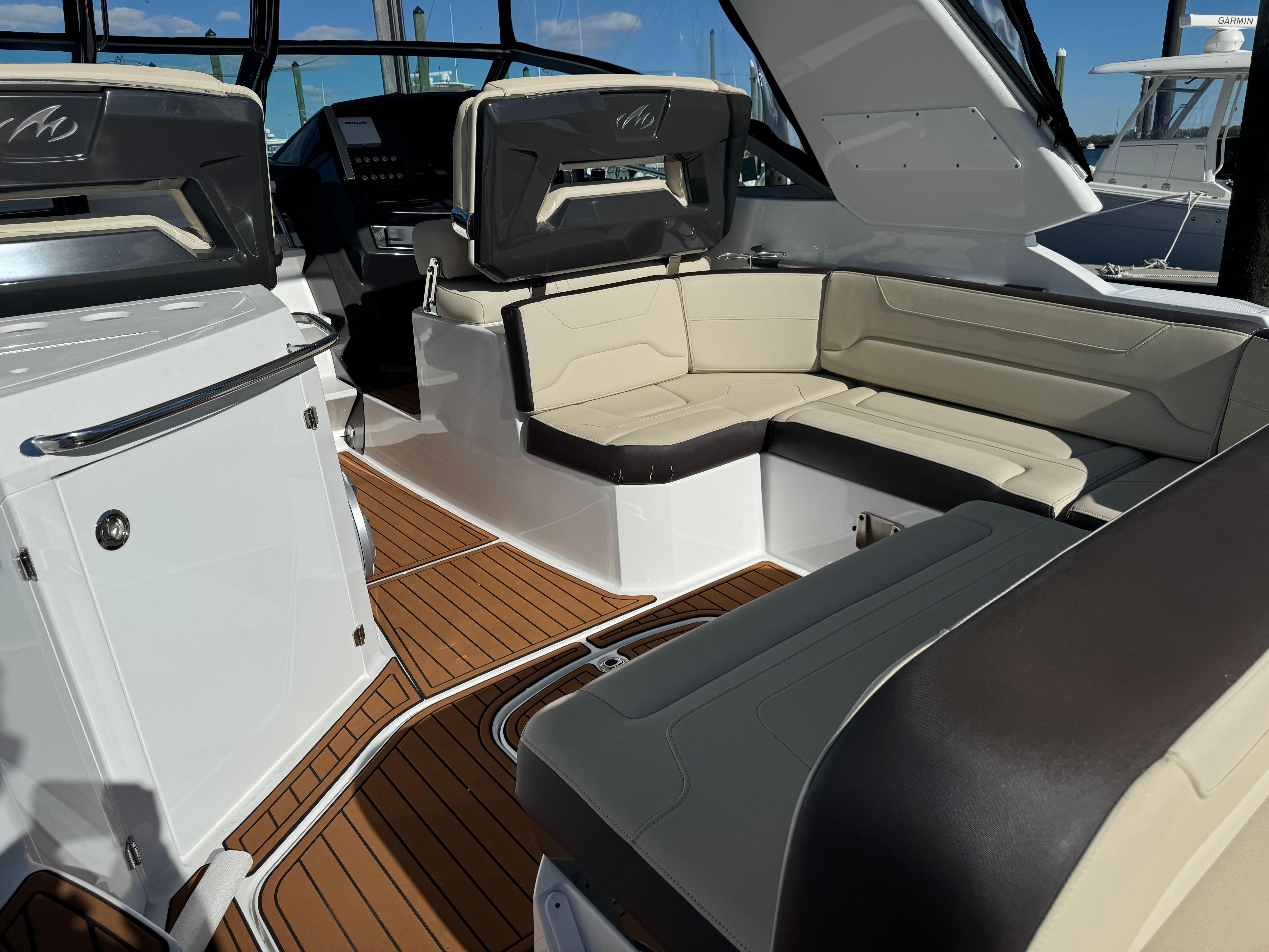 2018 Monterey 335 SY boat interior with beige seating and wood flooring.