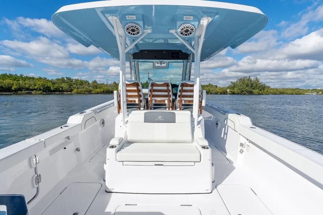 Manufacturer Provided Image: 2026 Bertram 34 CC boat interior with seating, on a calm waterway under a blue sky.