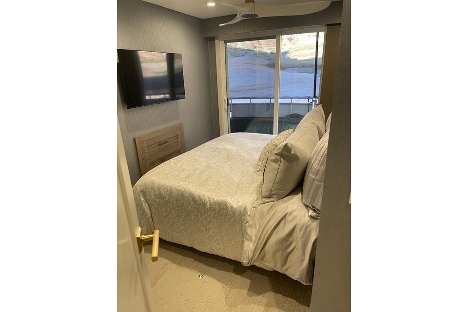 Luxurious bedroom on Adonia's 2021 "The Queen Elizabeth" with scenic window view.