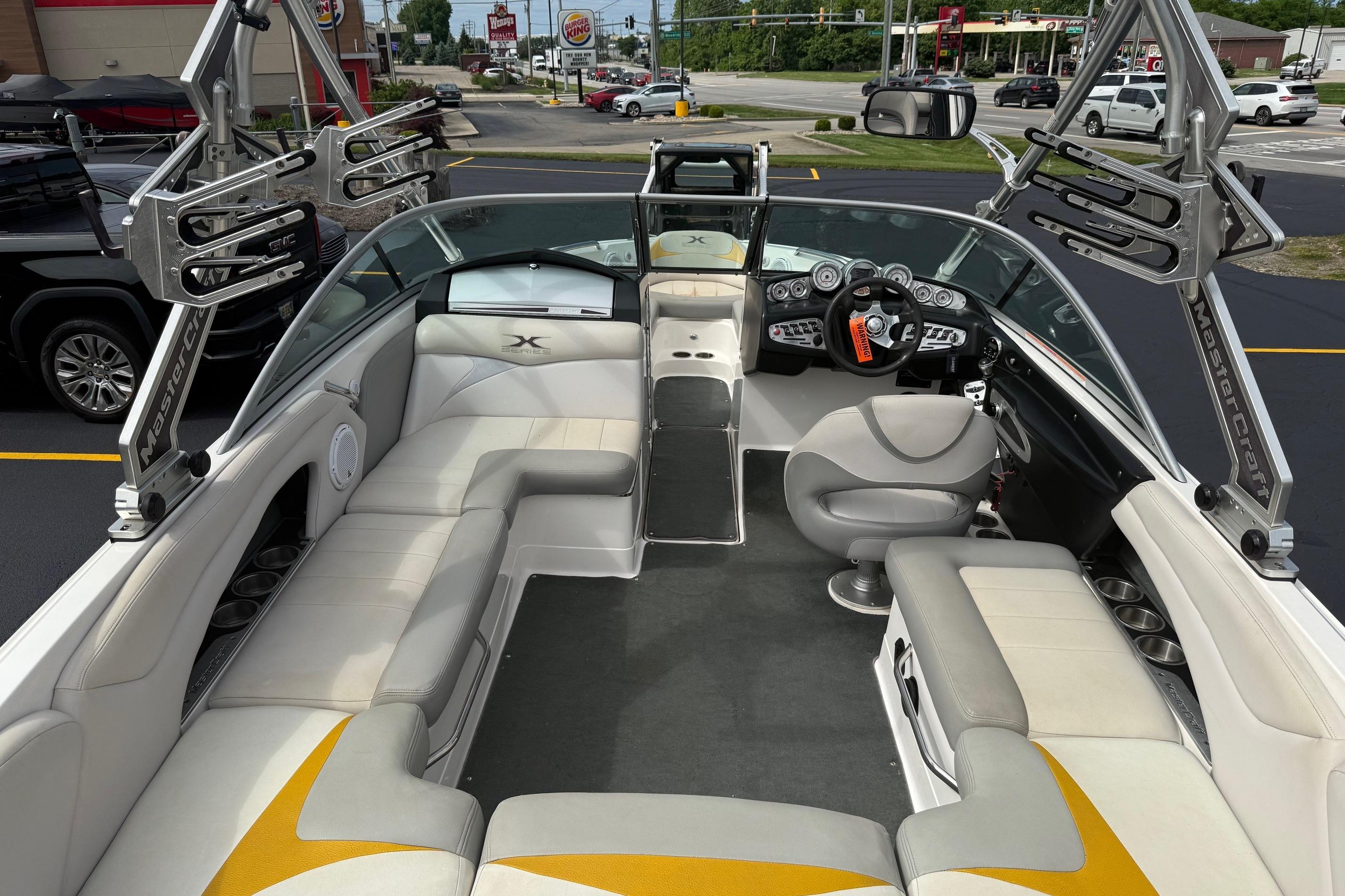 2008 MasterCraft X-15 boat interior with seating, steering wheel, and wakeboard racks.