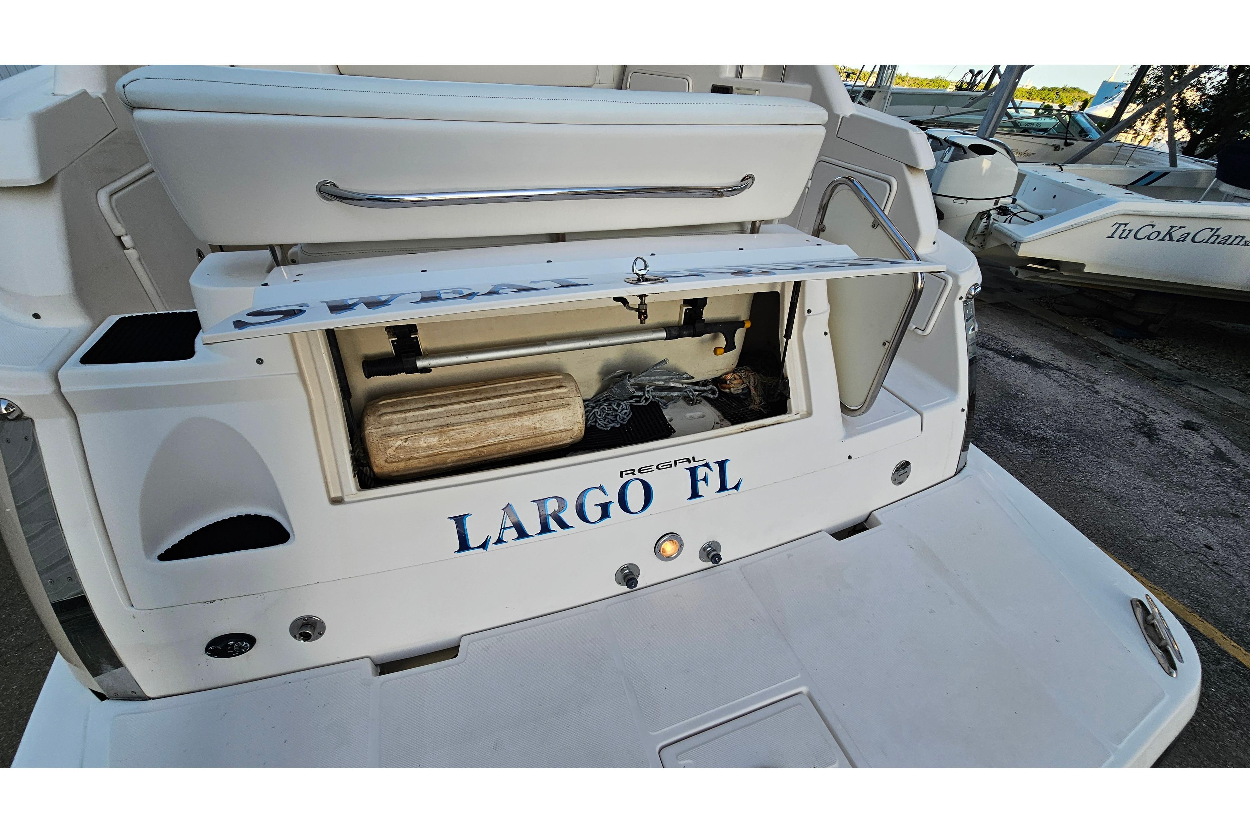 2005 Regal 3060 Window Express boat stern with storage compartment open, Largo FL.
