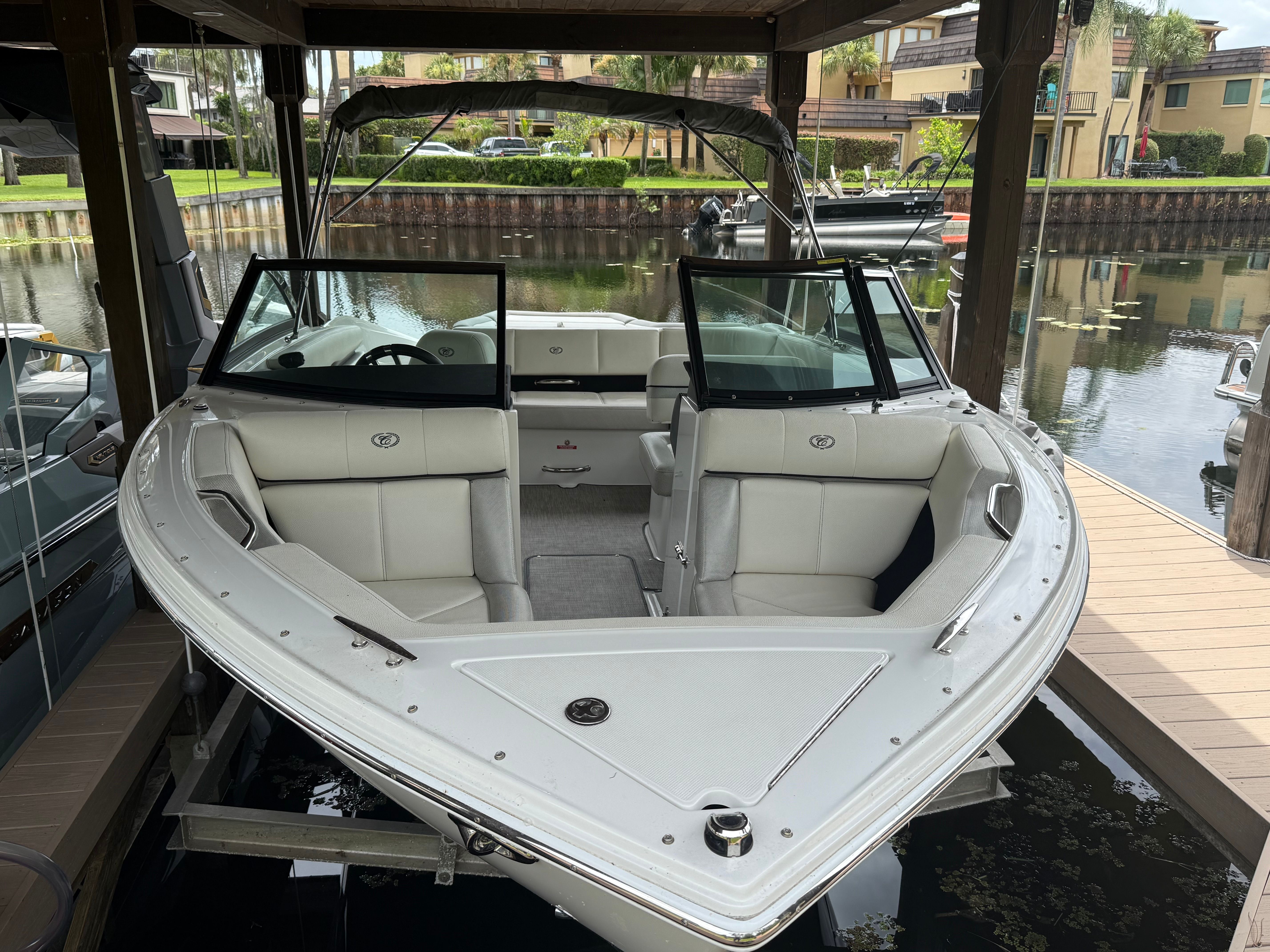 A white Cobalt CS22 Bowrider boat in a covered dock.