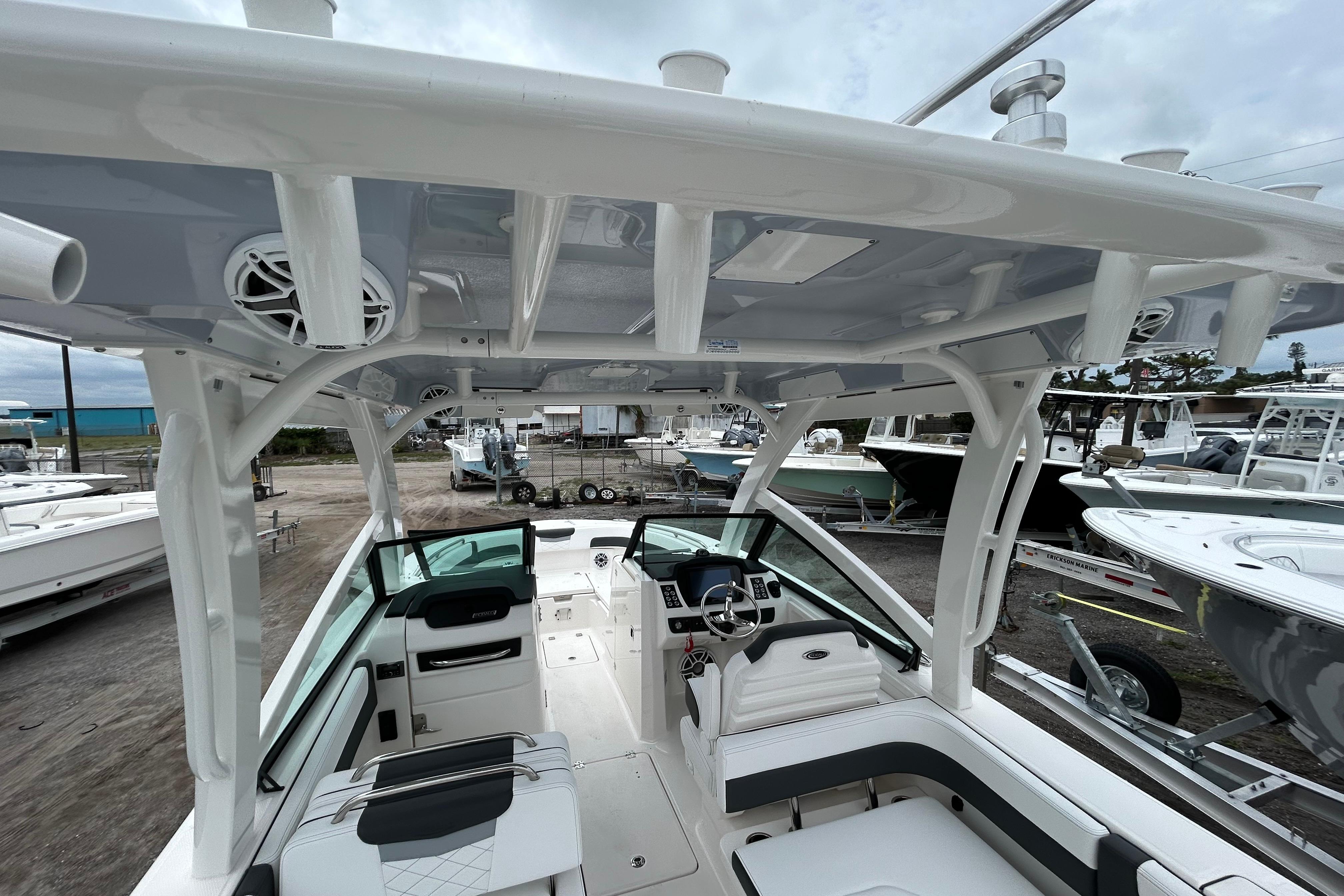 2026 Robalo R277 Dual Console boat interior with seating and helm, docked at a marina.